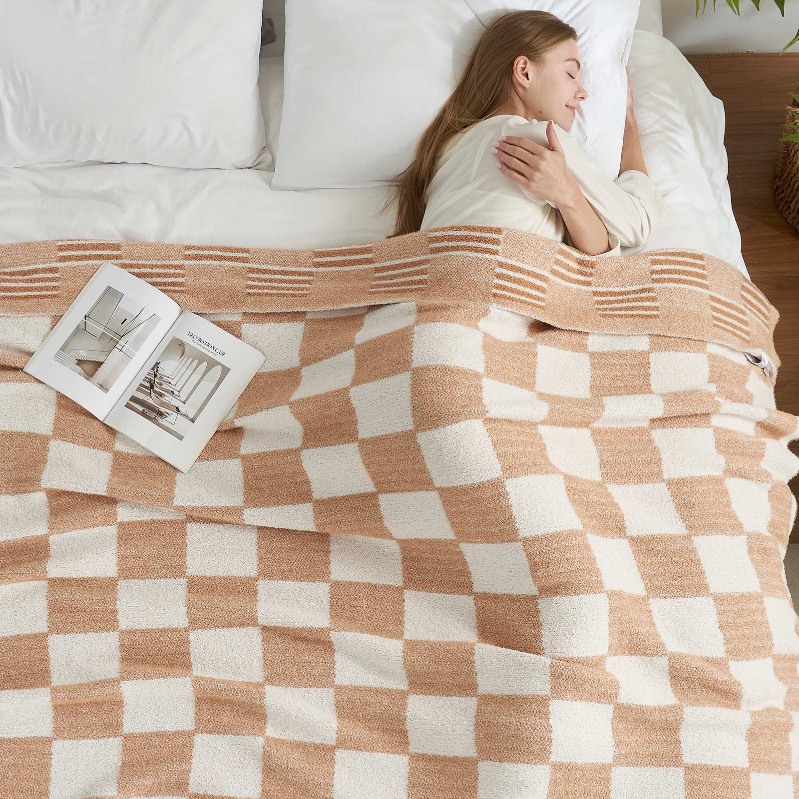 A woman laying on bed with Snuggle Sacs Reversible Heather Checkered Feather Yarn Knit Throw Blanket and a magazine #Color_Heather Beige