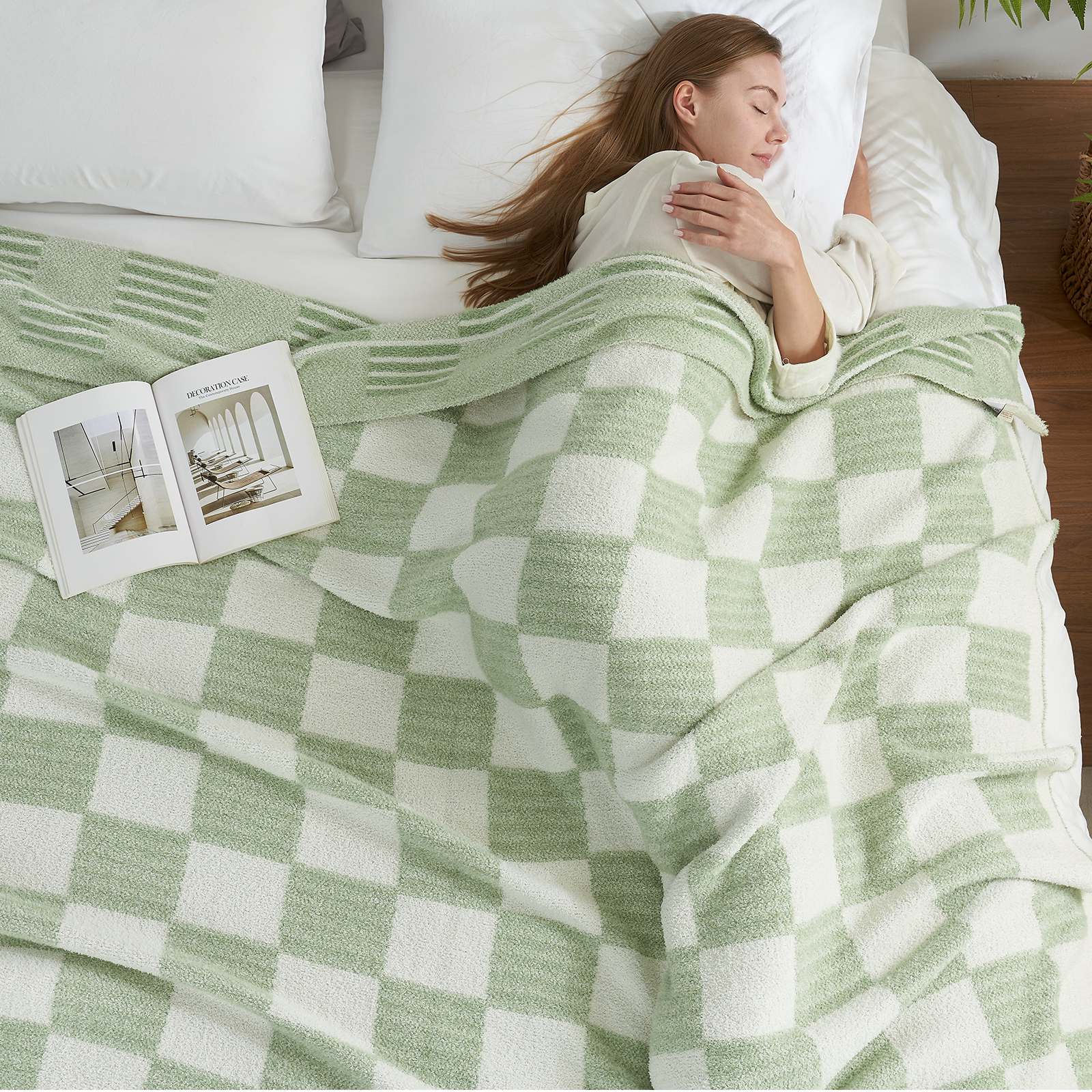 A woman laying on bed with Snuggle Sacs Reversible Heather Checkered Feather Yarn Knit Throw Blanket and a magazine #Color_Heather Sage Green