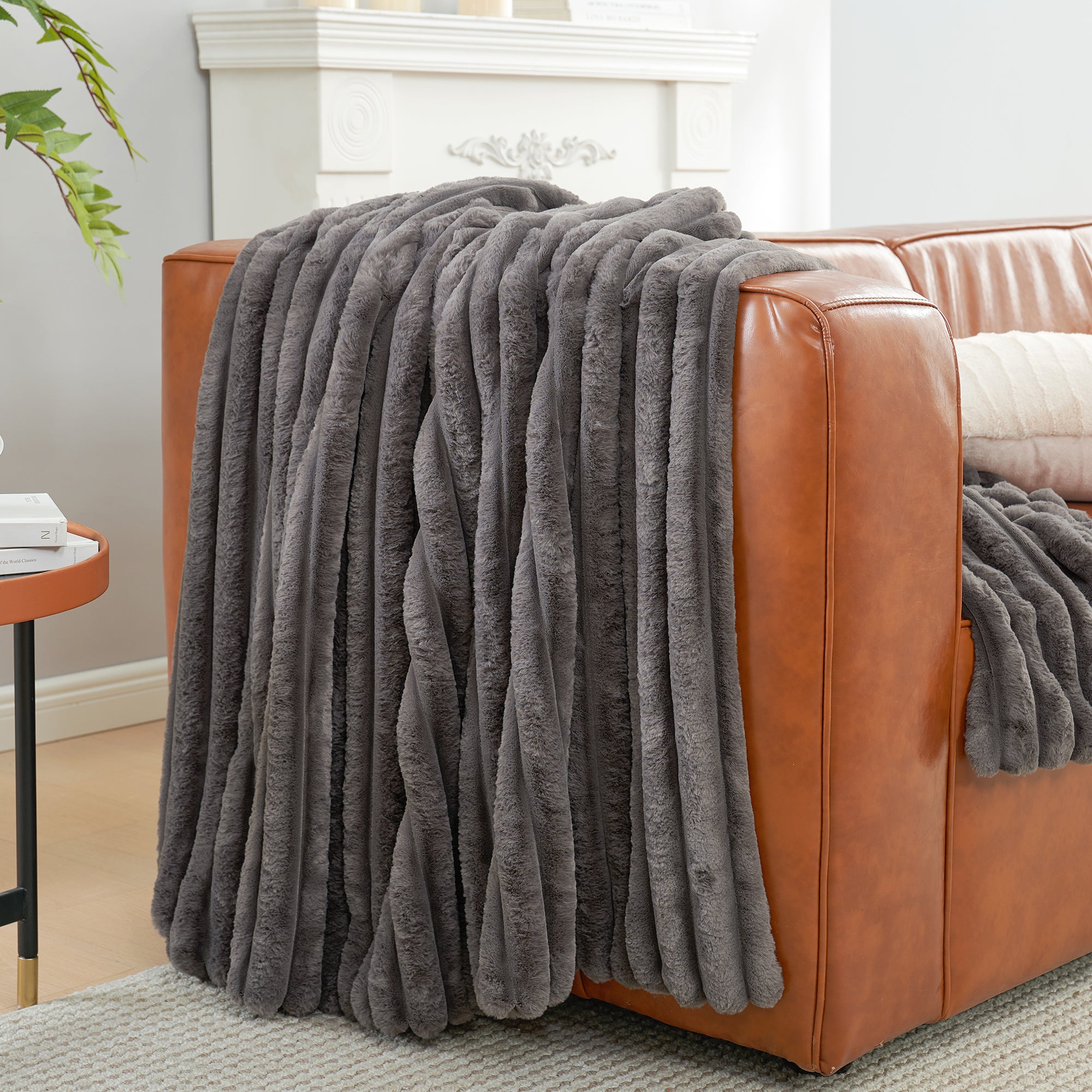 Striped faux fur throw blanket in Charcoal Grey draped over a sofa, creating a clean and cozy living space #color_Charcoal Grey