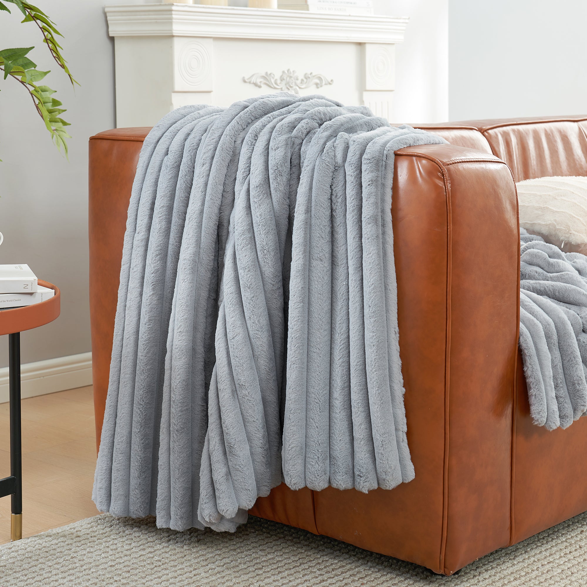 Striped faux fur throw blanket in Light Grey draped over a sofa, creating a clean and cozy living space #color_Light Grey