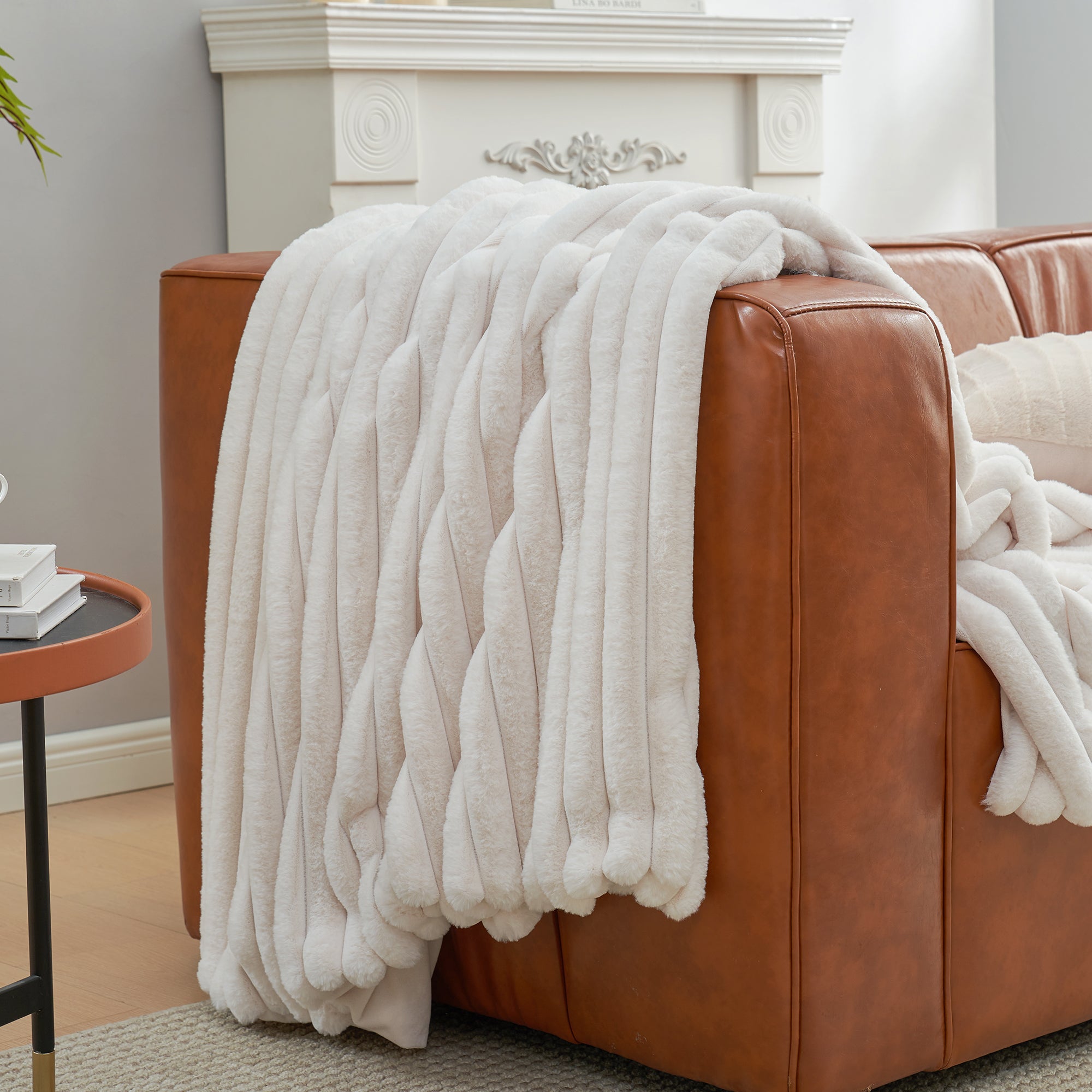 Snuggle Sac striped faux fur throw blanket in Ivory draped over a sofa, creating a clean and cozy living space #color_Ivory