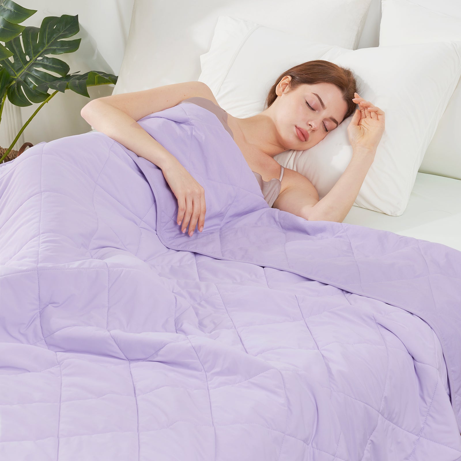 Woman sleeping under a Snuggle Sac purple comforter in a bedroom setting#color_Purple