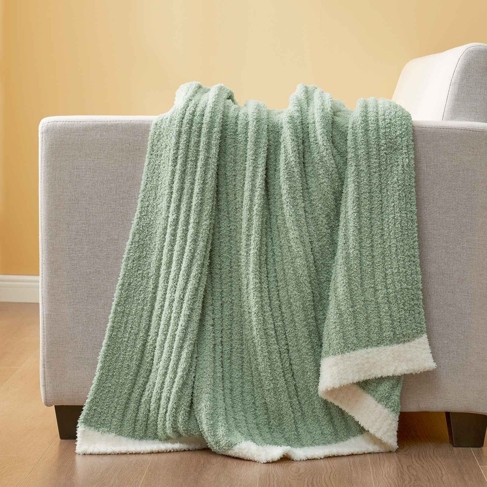 Snuggle Sac UltraSoft Ribbed Feather Yarn Knit Throw Blanket draped on the couch#Color_Sage Green