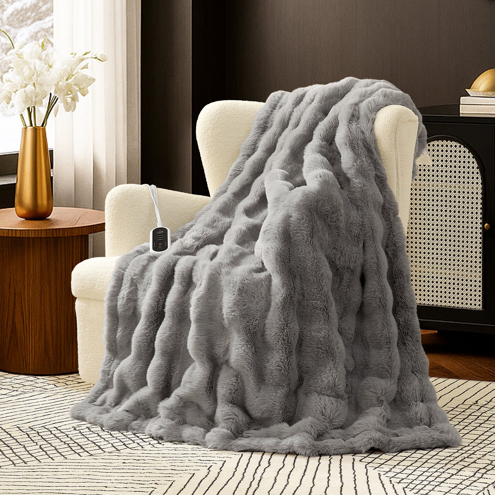 Snuggle Sac bubble faux fur electric blanket in Light Grey draped over a chair with controller, creating a warm and cozy setting #color_Light Grey