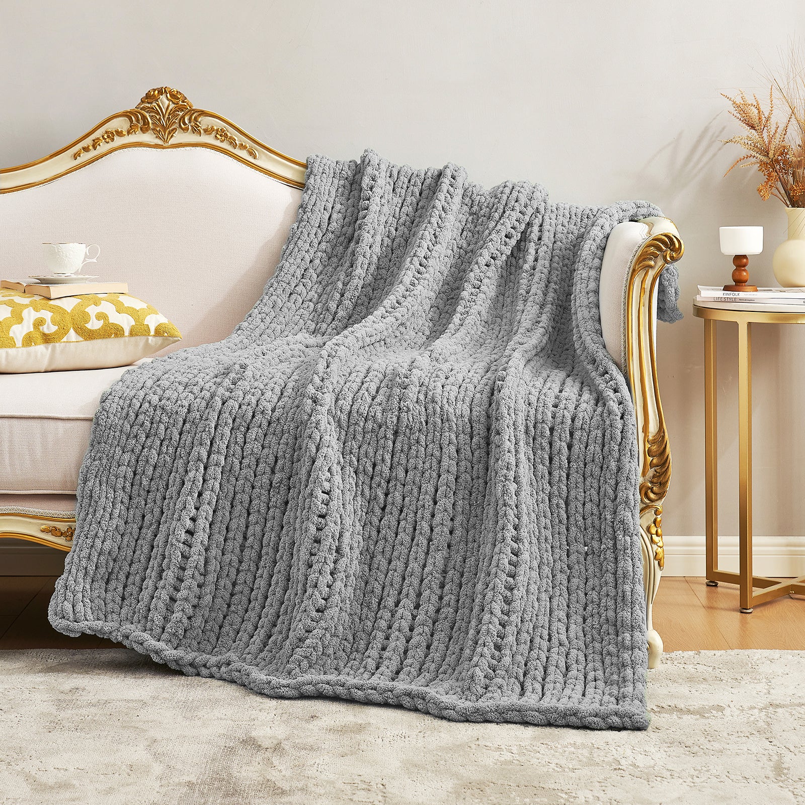 Chunky knit throw blanket in Light Grey spread over a sofa creating an elegant home look #color_Light Grey