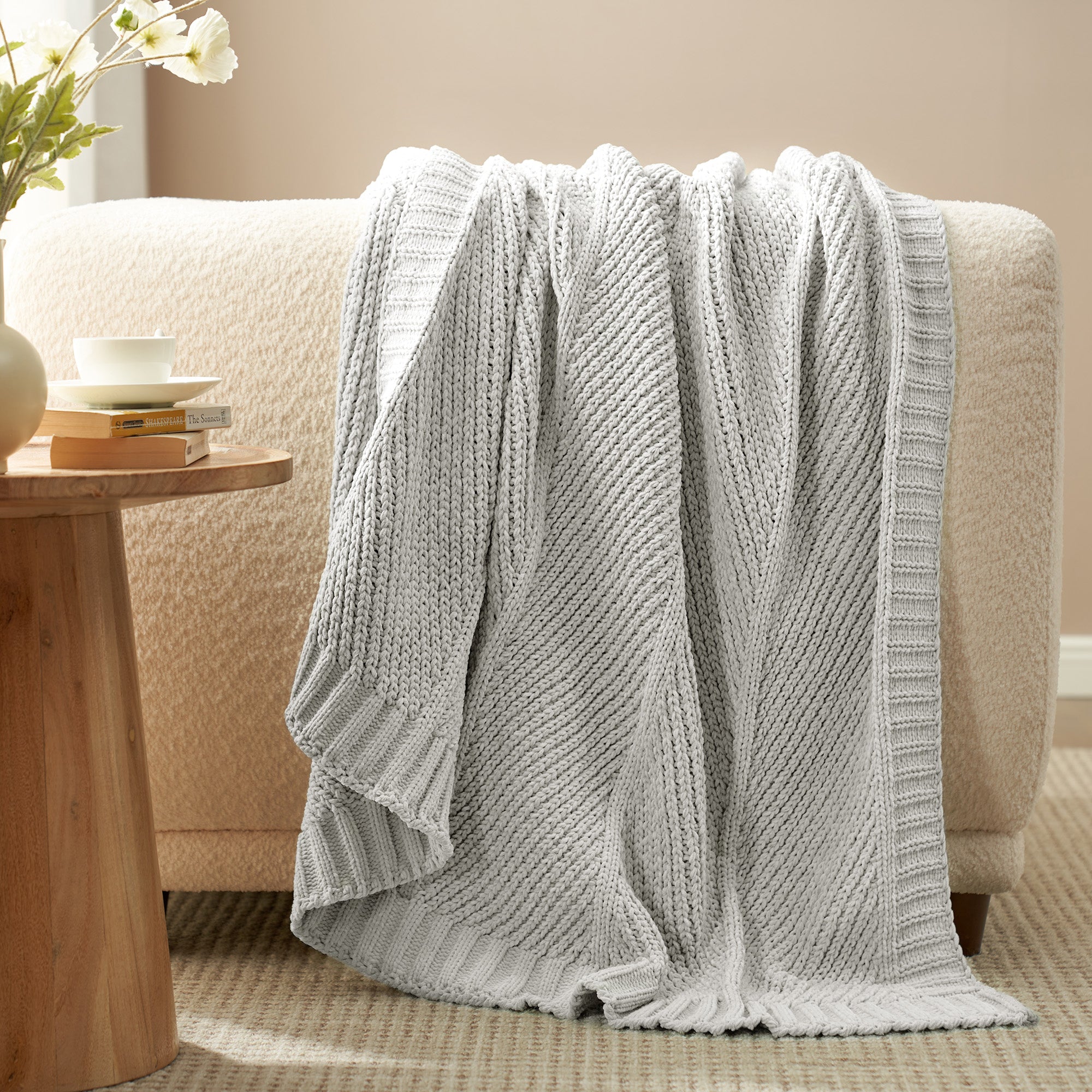 Snuggle Sac chevron chenille knit throw blanket  in Light Grey draped over a sofa creating a warm and inviting look #color_Light Grey