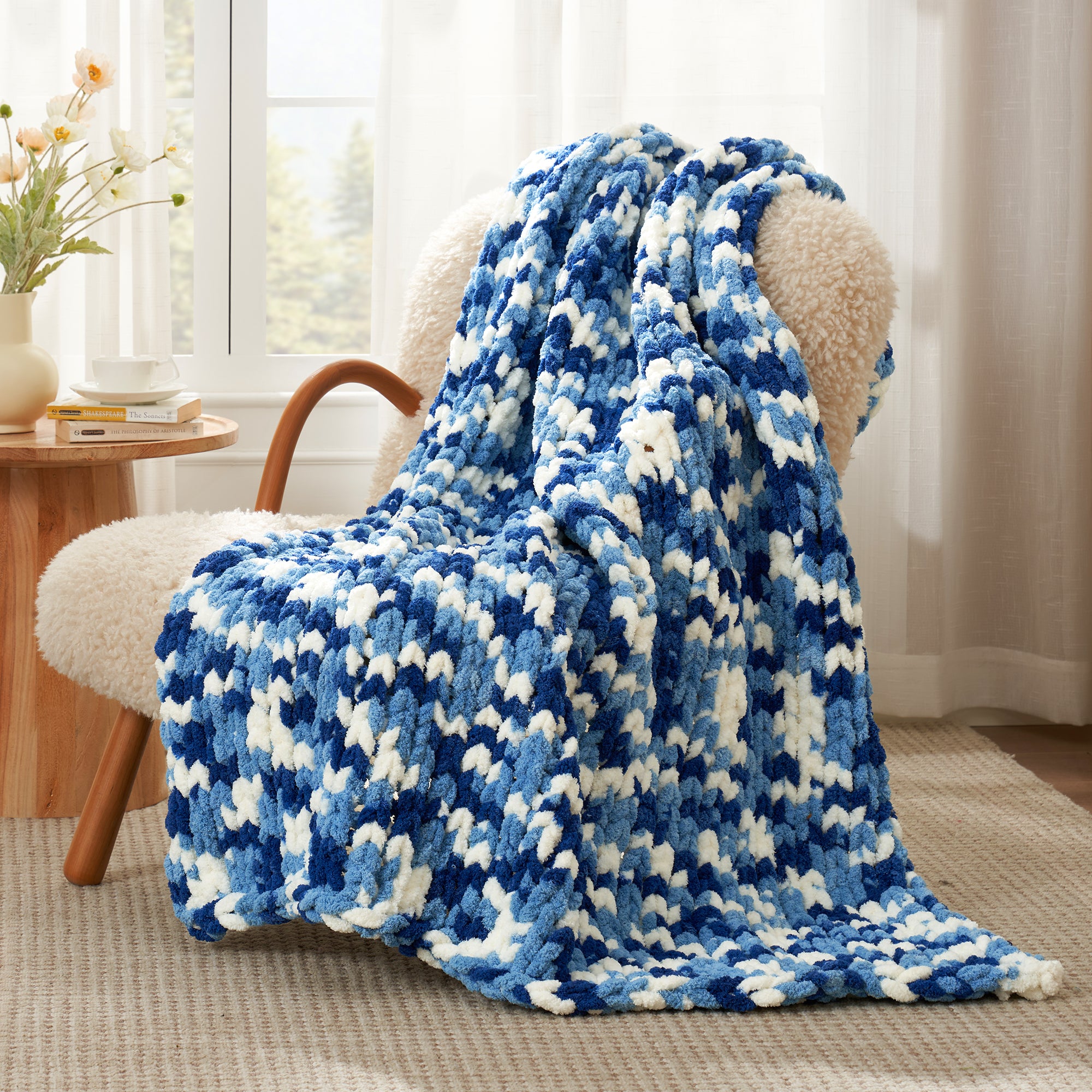 Snuggle Sac chunky chenille knit throw blanket in Blue draped over a chair creating a cozy corner #color_Blue