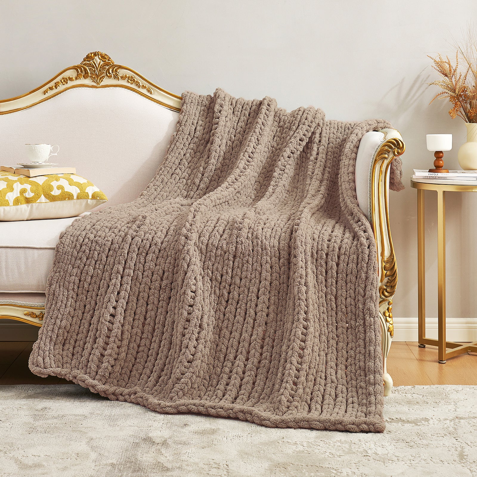 Textured chunky knit throw blanket in Beige elegantly spread over a sofa #color_Beige