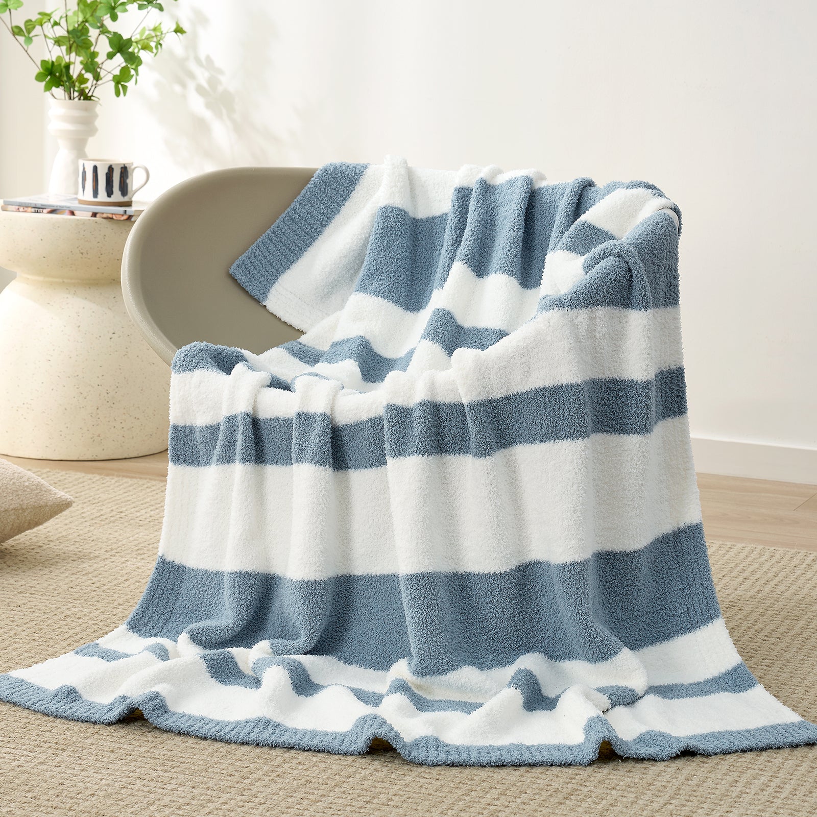 Snuggle Sacs Reversible Blue Striped Feather Yarn Knit Throw Blanket on a grey chair in a bright room#color_Blue