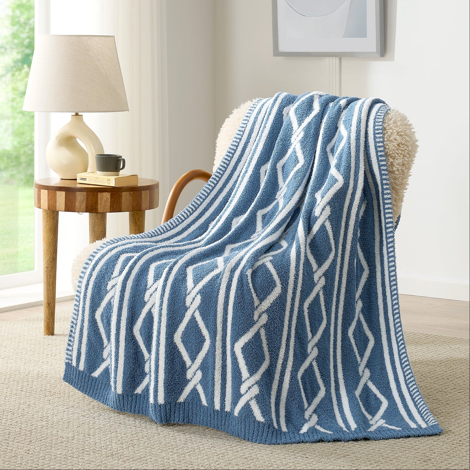 Snuggle Sacs Aesthetic Boho Feather Yarn Knit Throw Blanket on the chair with lamp and window behind#color_Blue