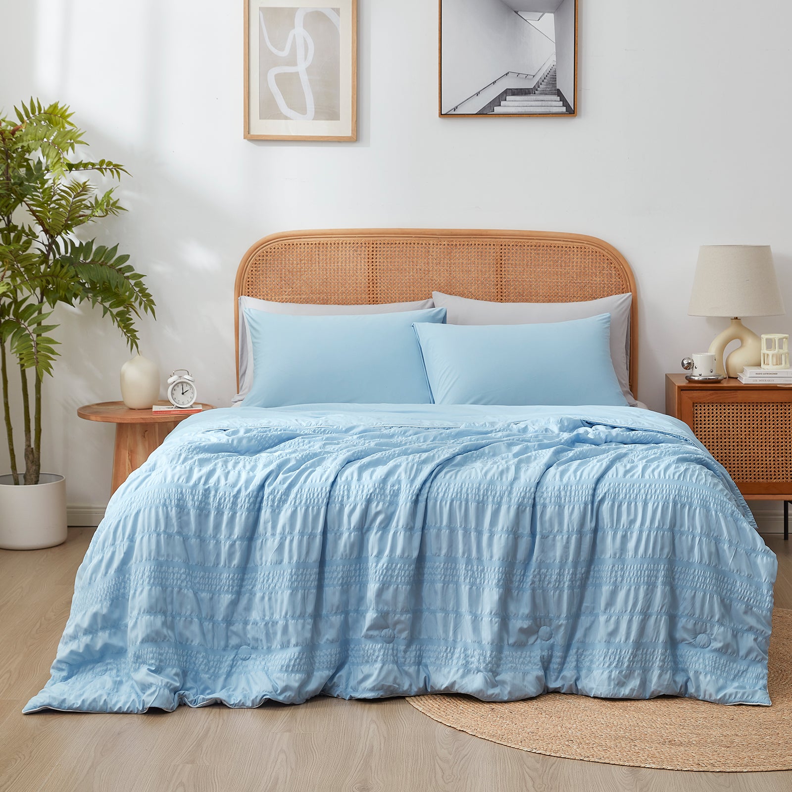 Snuggle Sac Cooling comforter in blue on bed in a bedroom with plants
#color_Blue