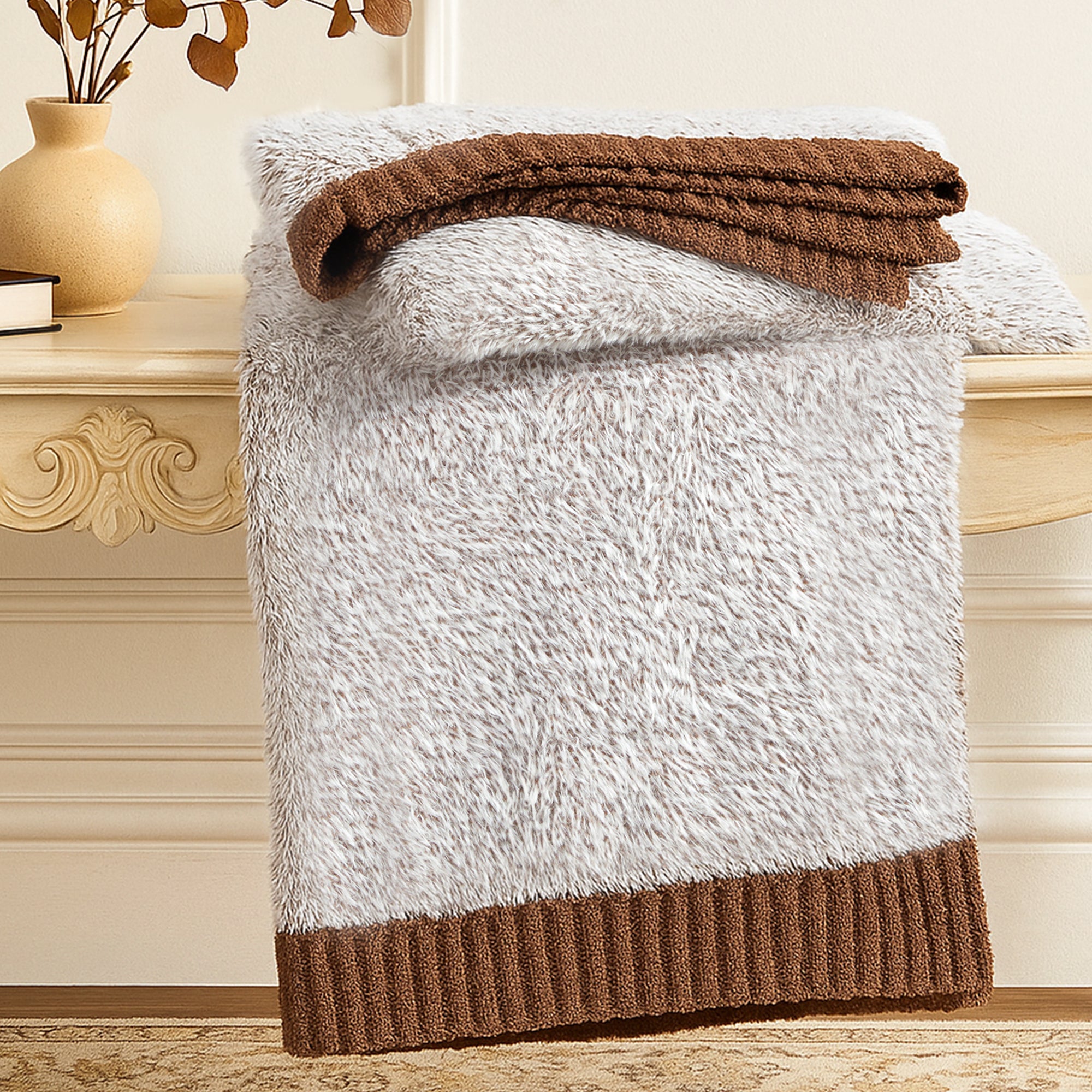 Ultrasoft faux fur knit throw blanket in Brown neatly folded on a wooden table, showcasing thick and plush texture #color_Brown