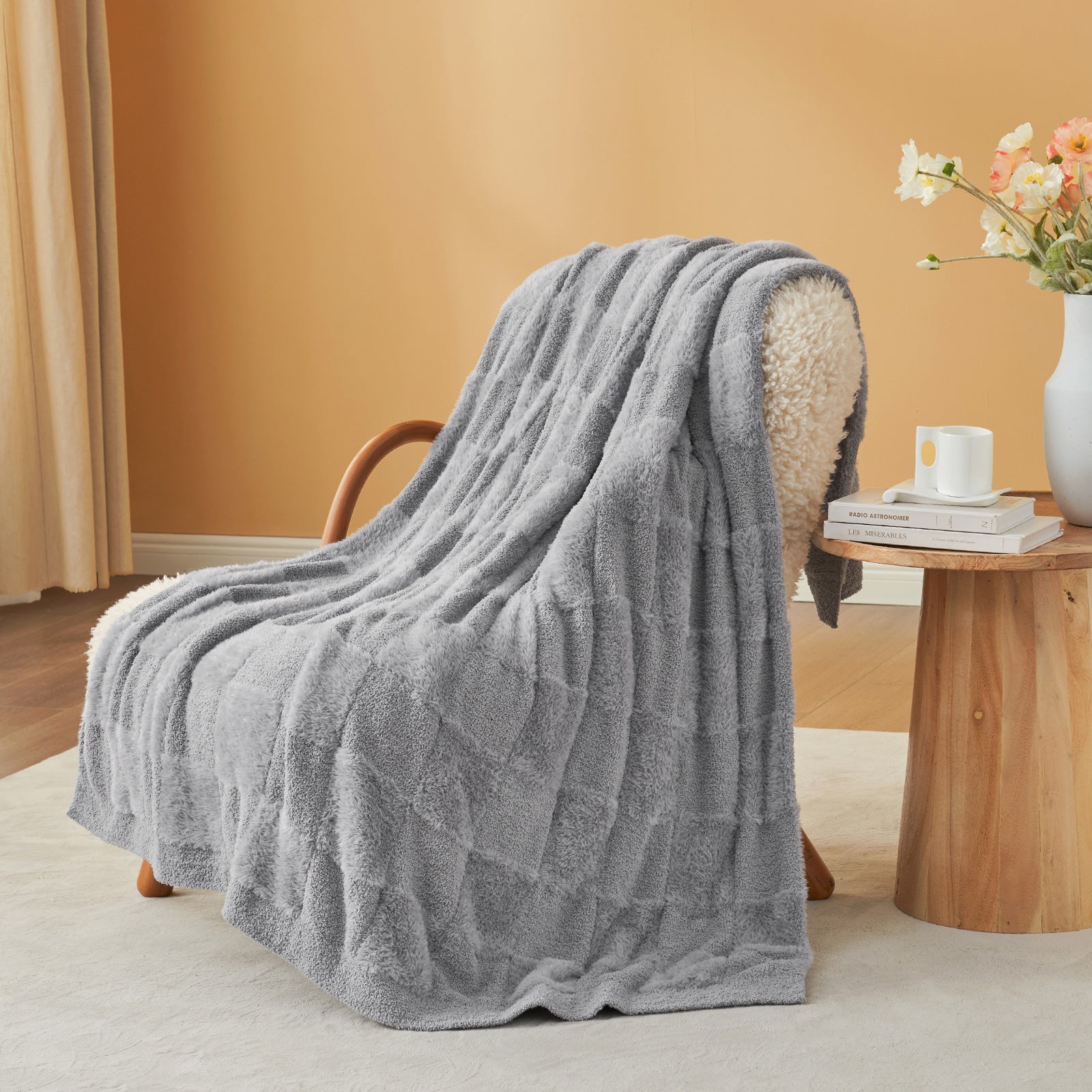 UltraCozy Solid Checkered Feather Yarn Knit Throw Blanket on a beige chair with candle and magazine - #Color_Solid Light Grey