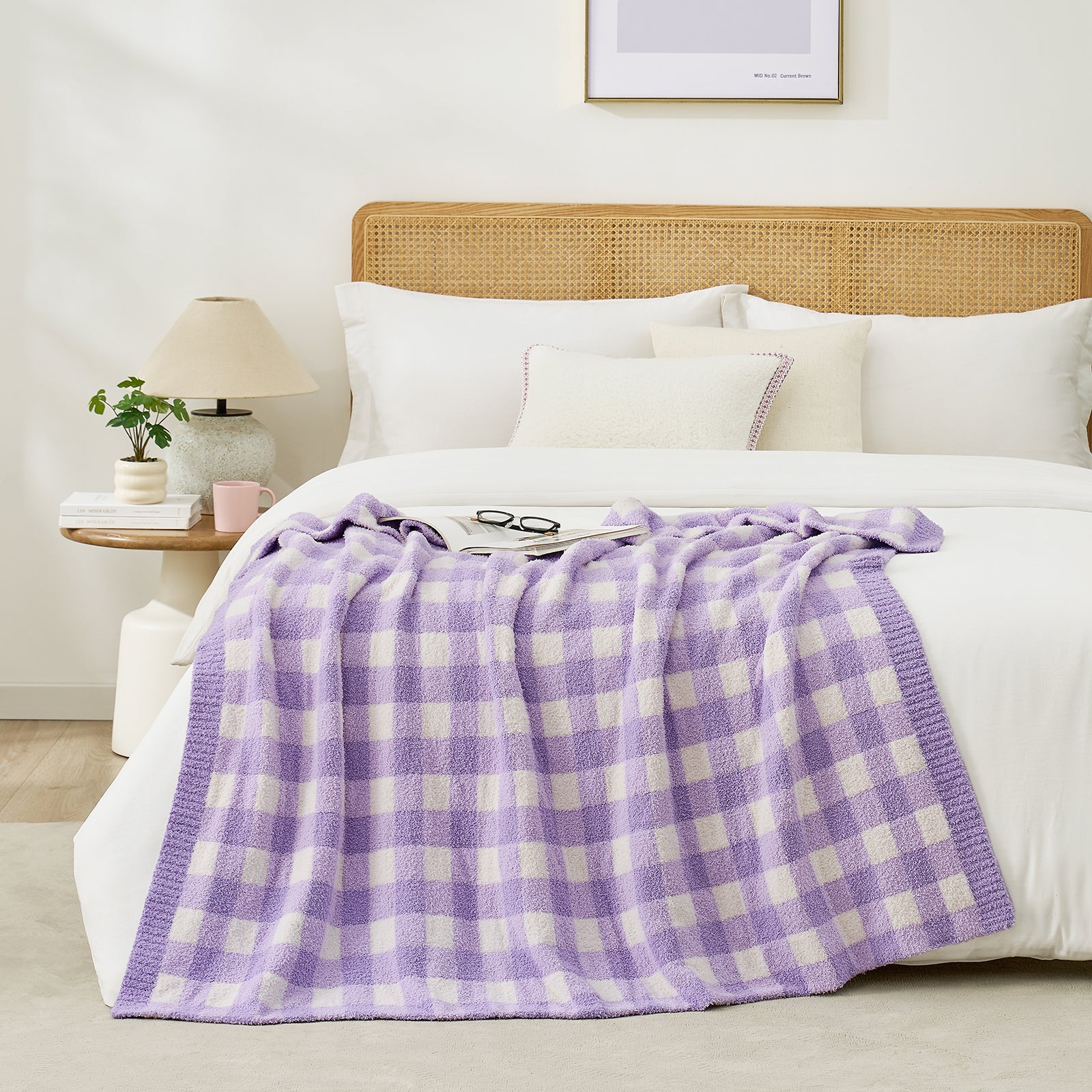 Purple and white checkered blanket draped over a bed with a glasses and magazine in a bright room #color_Purple