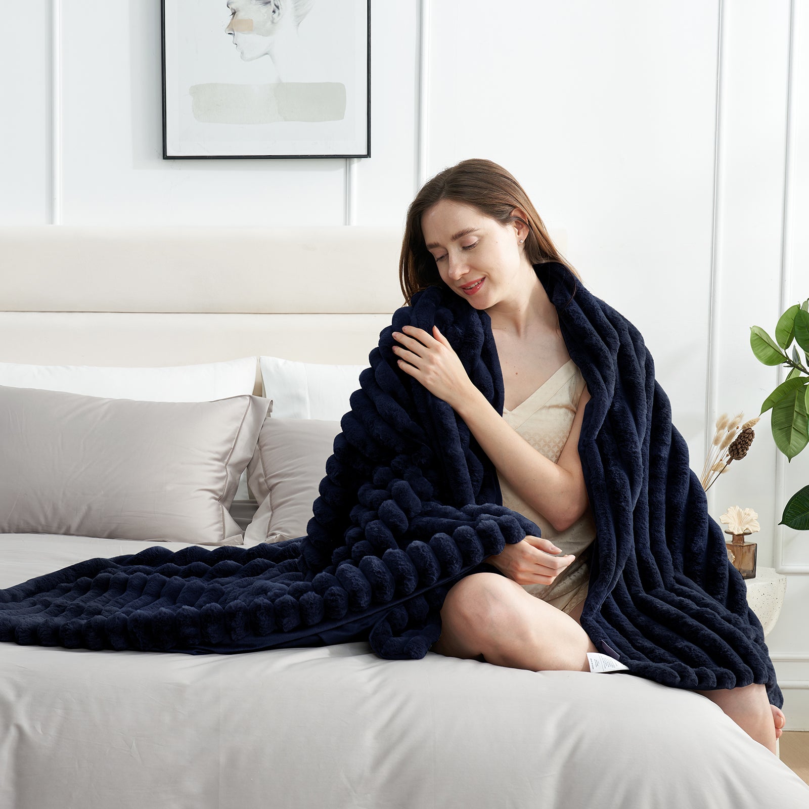Woman relaxing on bed with a striped faux fur throw blanket in Navy Blue #color_Navy Blue