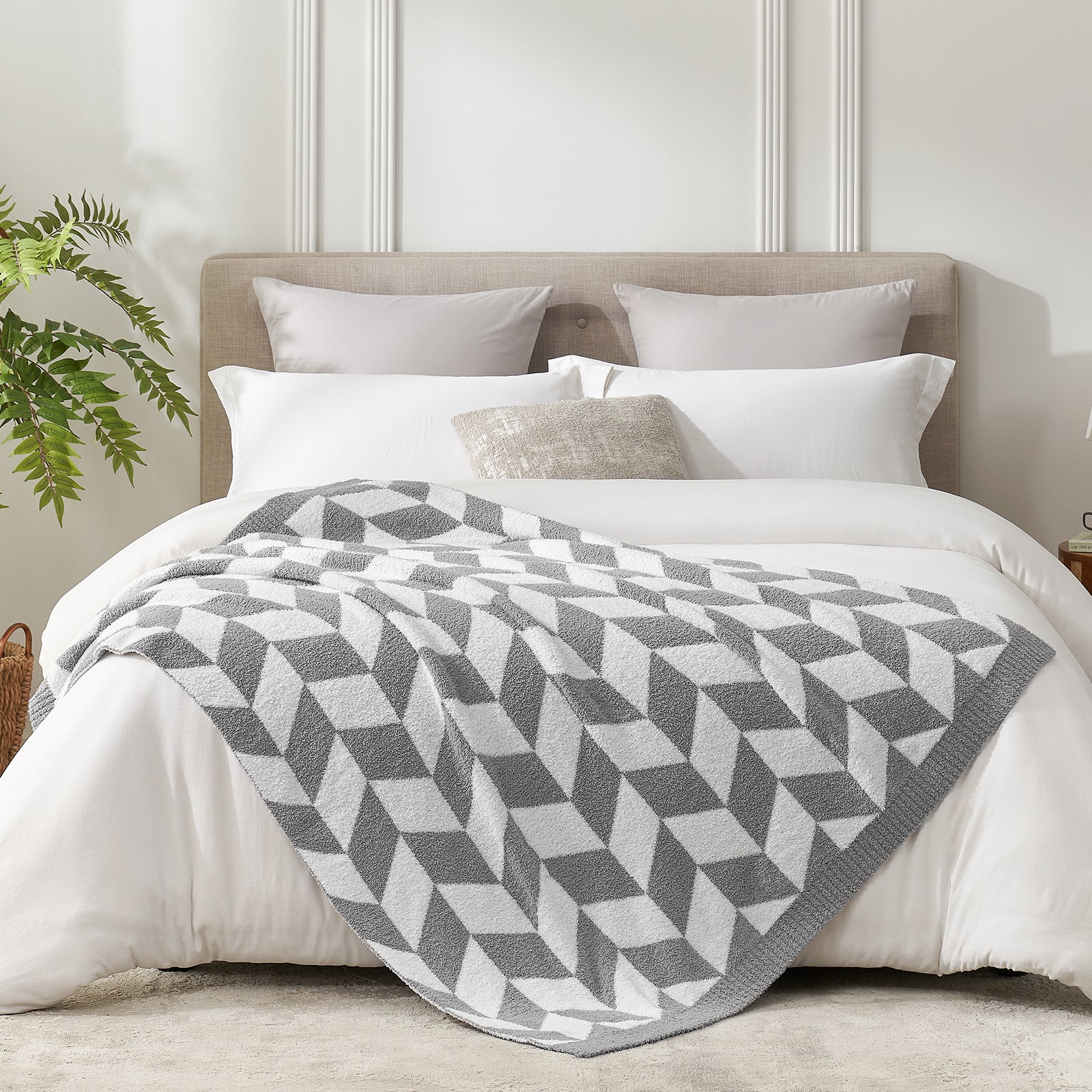 Snuggle Sacs Chevron Feather Yarn Knit Throw Blanket on the bed with plant next to it#color_Grey
