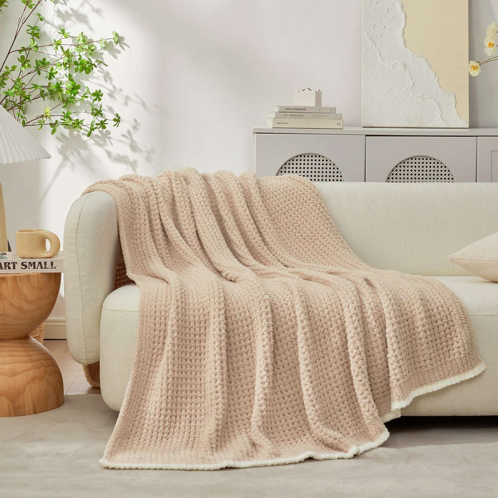  Soft Waffle Feather Yarn Knit Throw Blanket draped on a beige couch with furnitures behind #Color_Beige