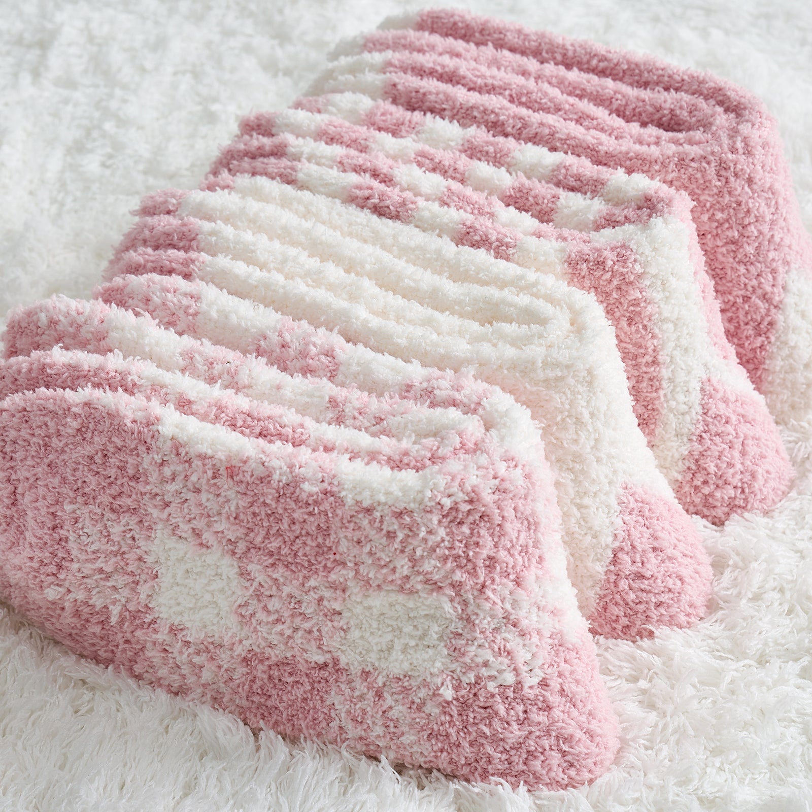 Women checkered and striped socks 4 pairs in Pink folded together, showcasing soft fuzzy texture and winter patterns #color_Pink