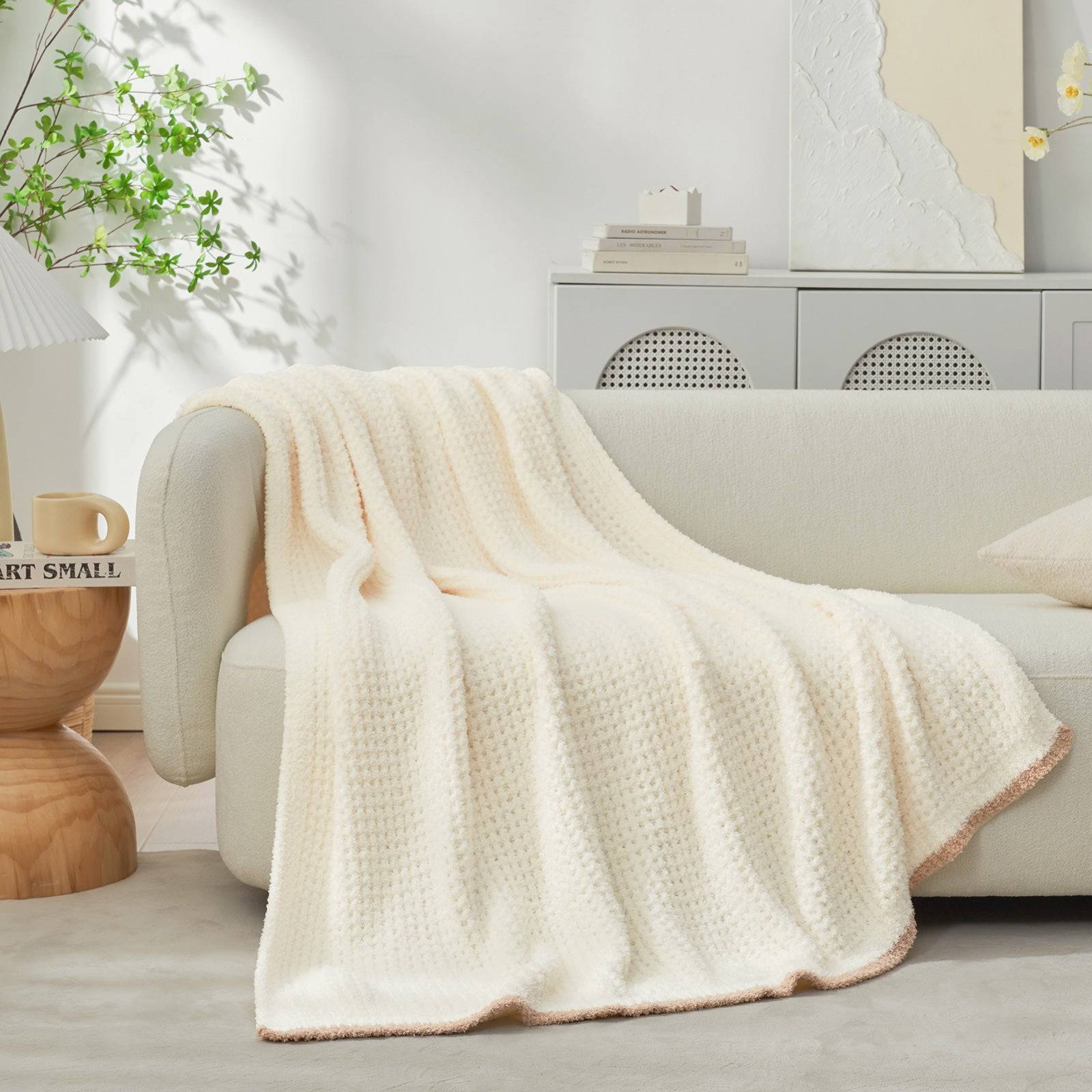 Soft Waffle Feather Yarn Knit Throw Blanket  draped over a beige sofa#Color_Cream
