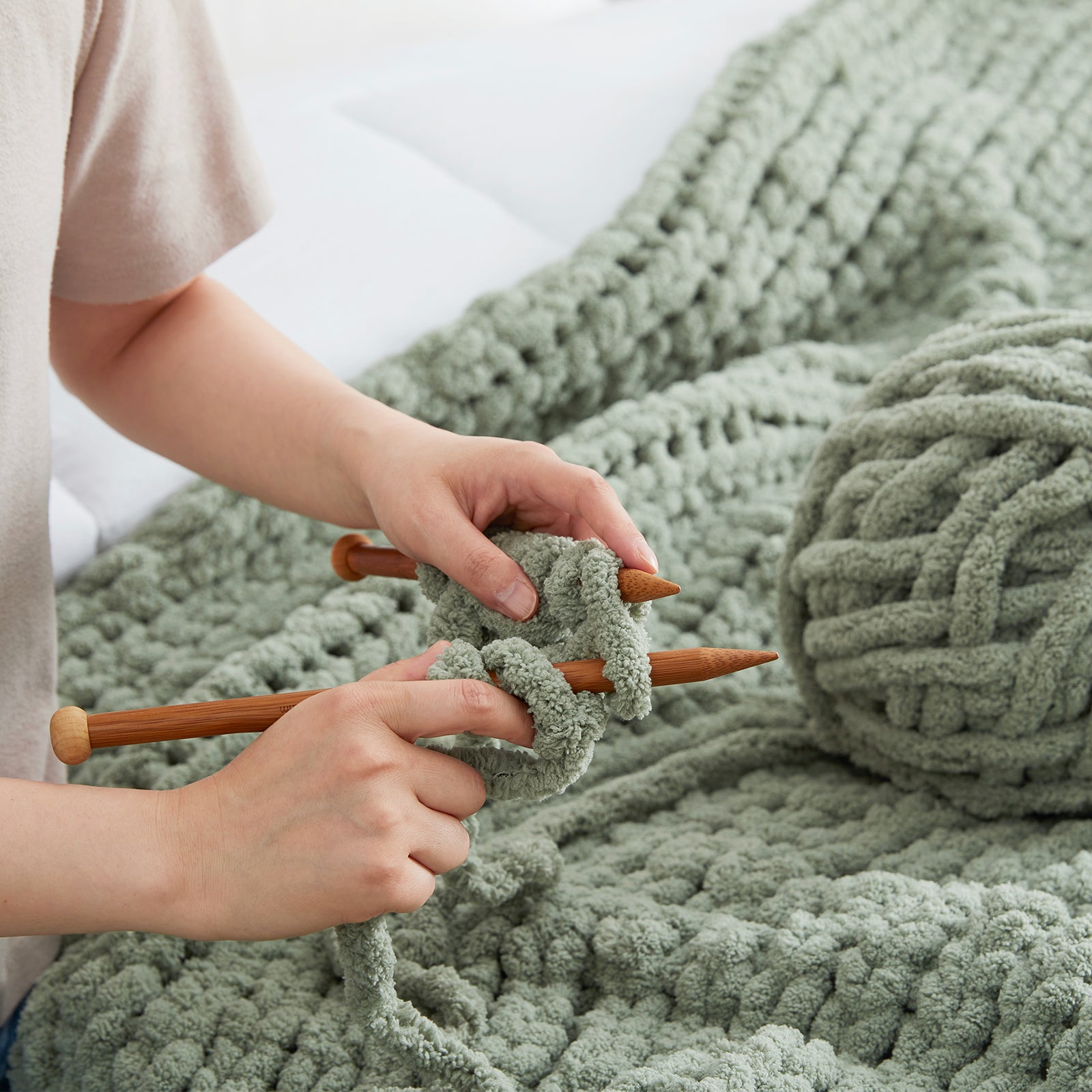 Close up of chunky yarn knitting texture showing thick loops and softness #color_Sage Green