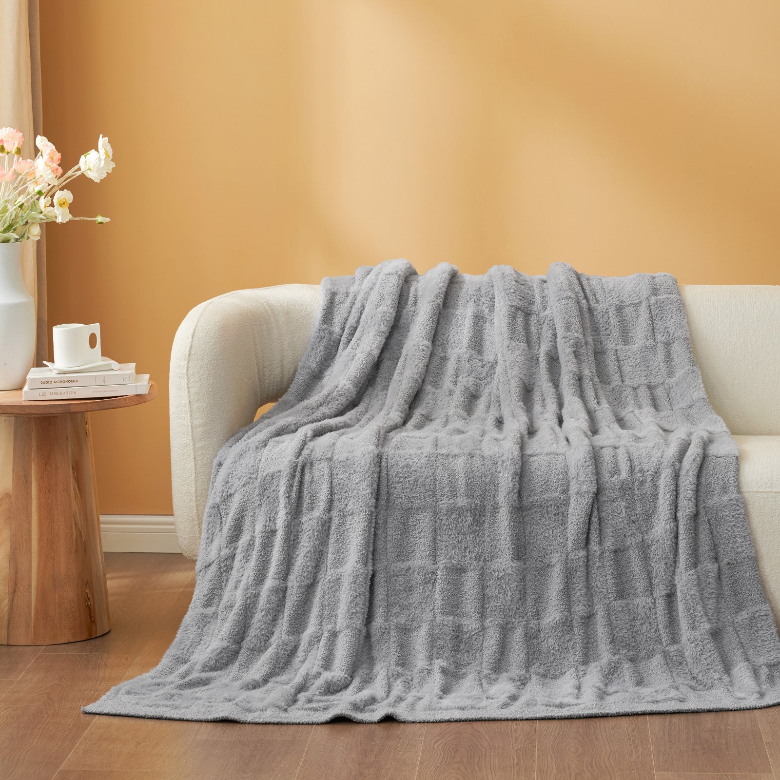 UltraCozy Solid Checkered Feather Yarn Knit Throw Blanket on a beige couch - #Color_Solid Light Grey
