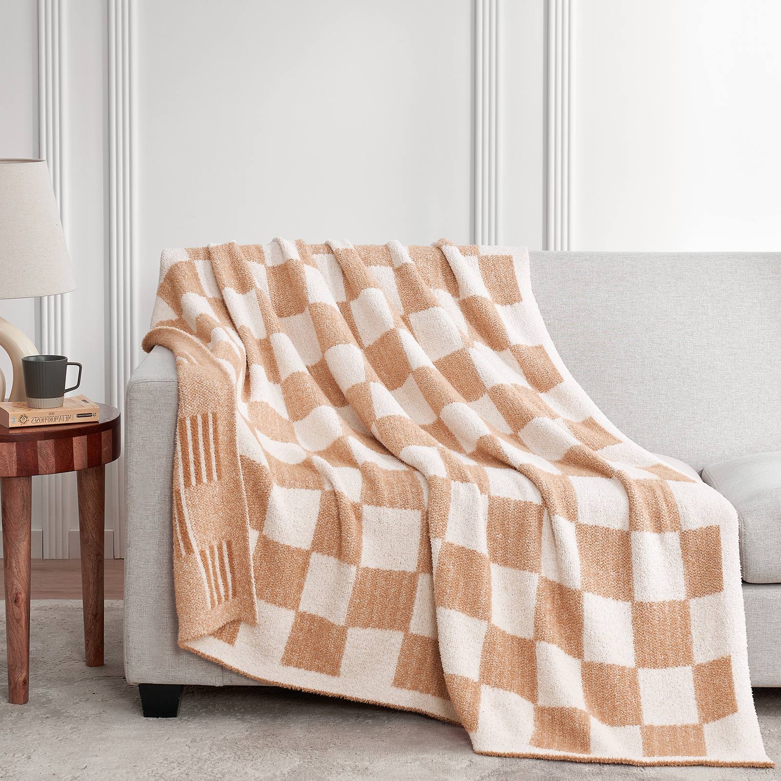 Snuggle Sacs Reversible Heather Checkered Feather Yarn Knit Throw Blanket draped on a grey couch#Color_Heather Beige