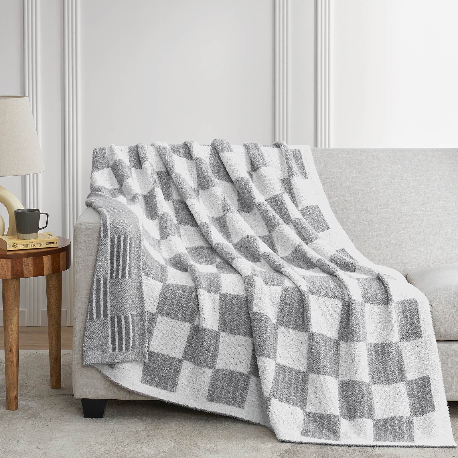 Snuggle Sacs Reversible Heather Checkered Feather Yarn Knit Throw Blanket draped on a grey couch#Color_Heather Grey