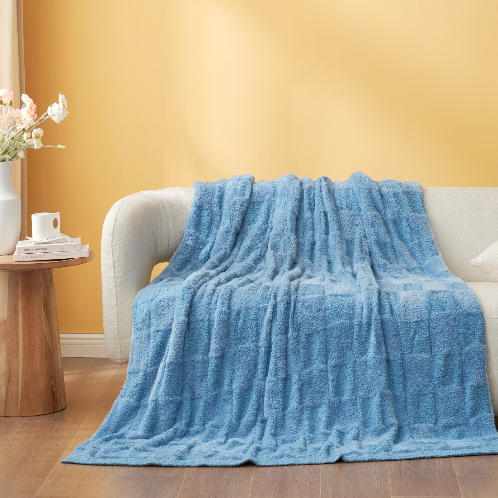 UltraCozy Solid Checkered Feather Yarn Knit Throw Blanket on a beige couch #Color_Solid Blue