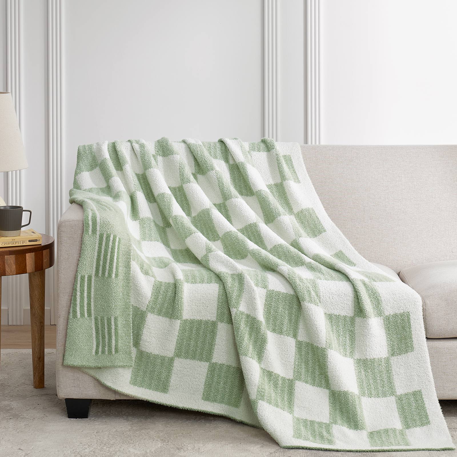 Snuggle Sacs Reversible Heather Checkered Feather Yarn Knit Throw Blanket draped on a grey sofa#Color_Heather Sage Green
