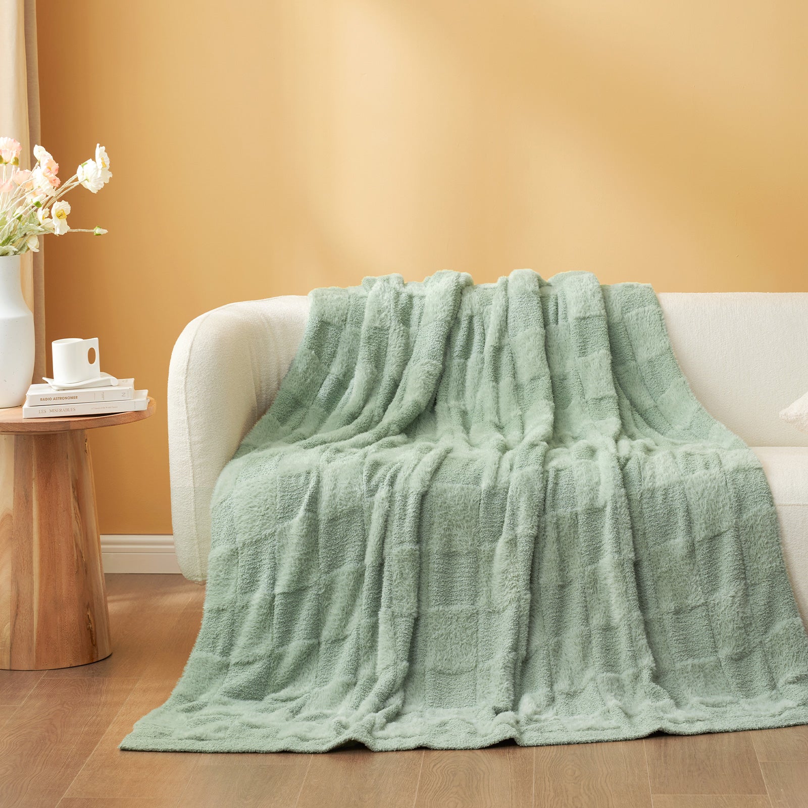 UltraCozy Solid Checkered Feather Yarn Knit Throw Blanket on a beige couch - #Color_Sage Green