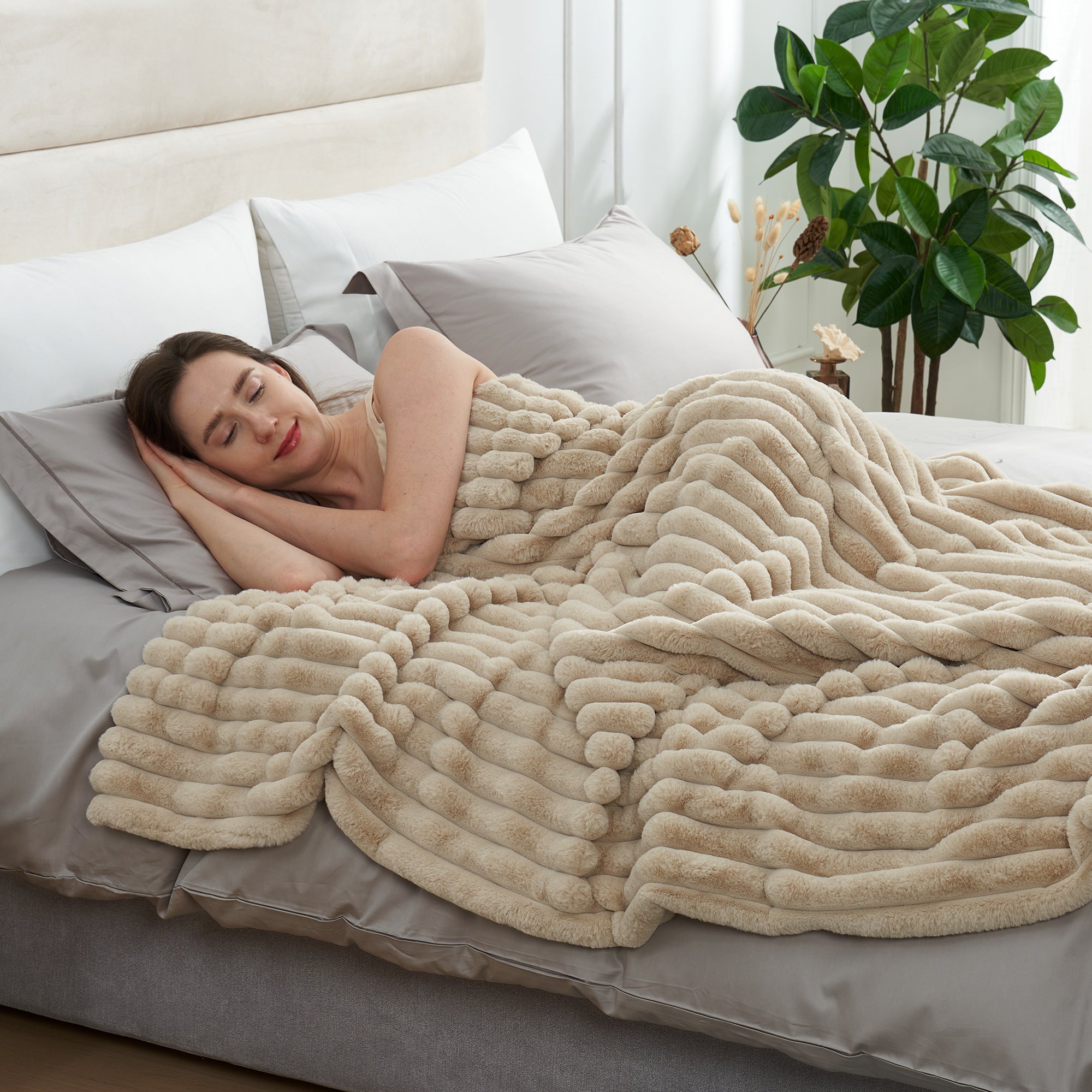 Woman sleeping under a striped faux fur throw blanket in Beige for soft and comfortable warmth #color_Beige