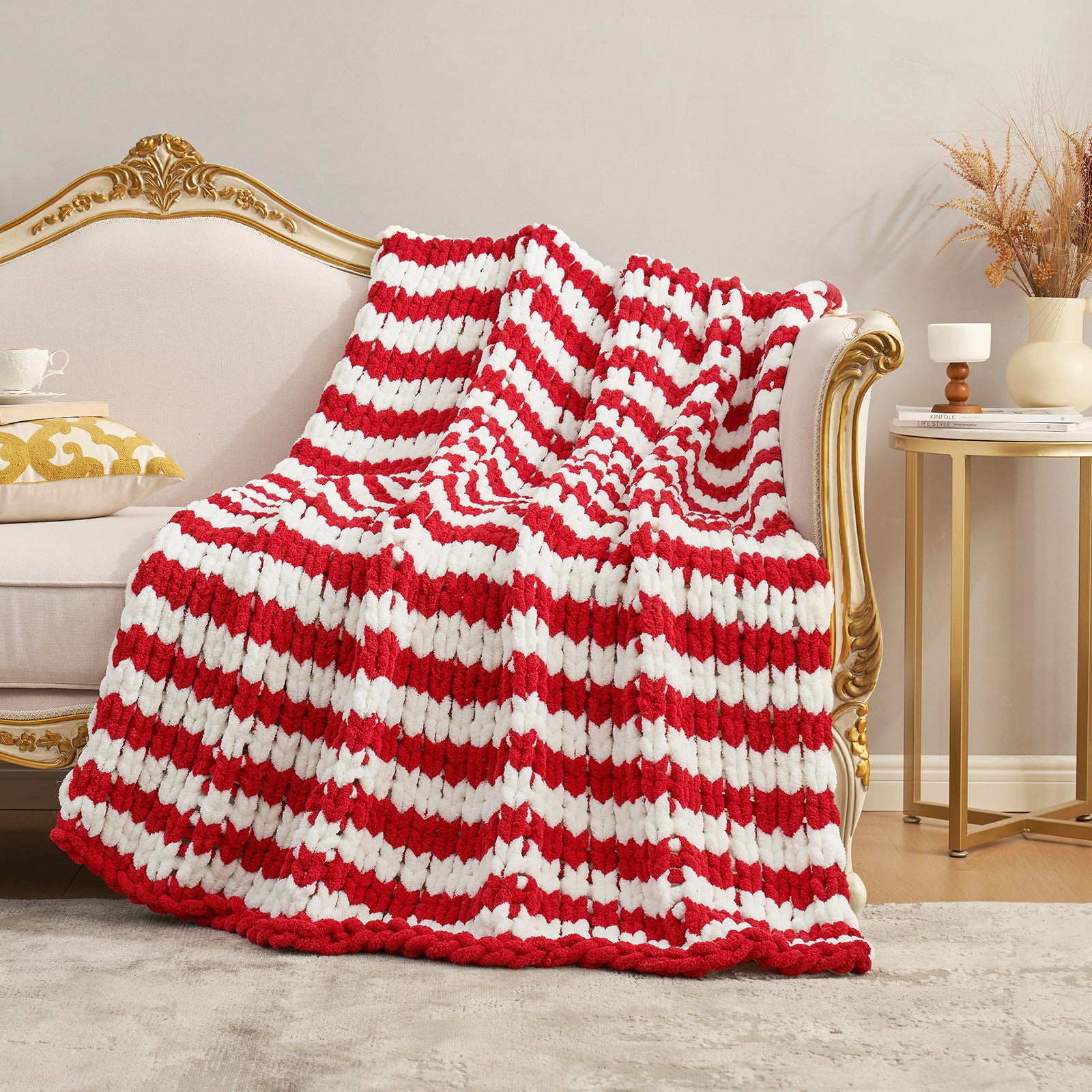 Handmade chunky chenille knit throw blanket in Red Stripe draped over a sofa, creating a warm atmosphere. #color_Red Stripe
