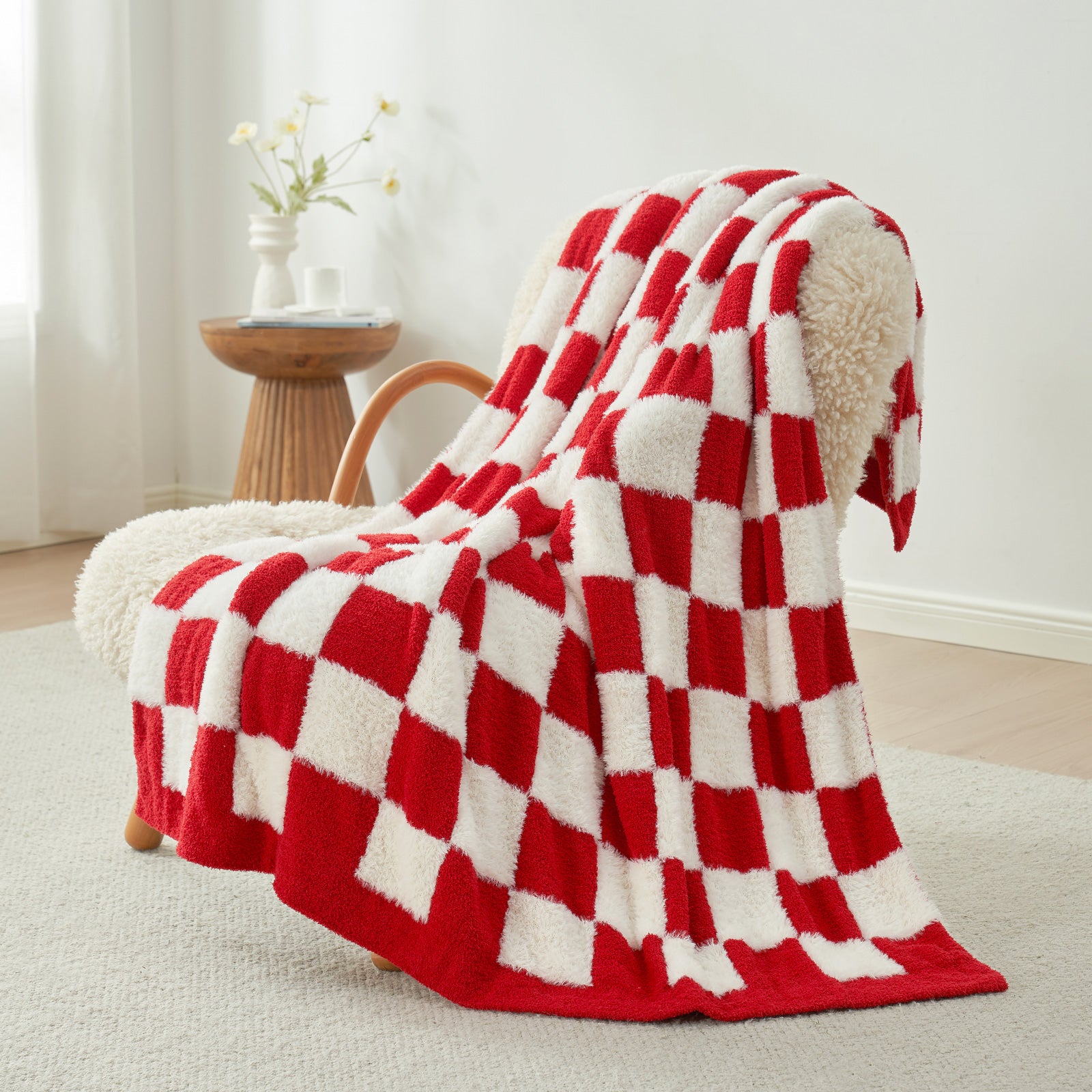 UltraCozy Checkered Feather Yarn Knit Throw Blanket on a beige chair#Color_Red/Cream