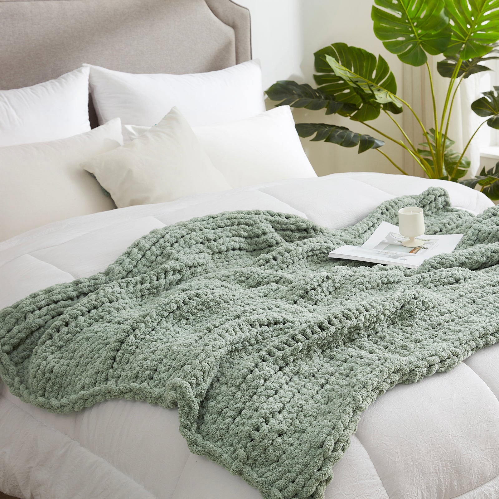 Soft chunky knit throw blanket in Sage Green layered on bed in a modern bedroom setting #color_Sage Green