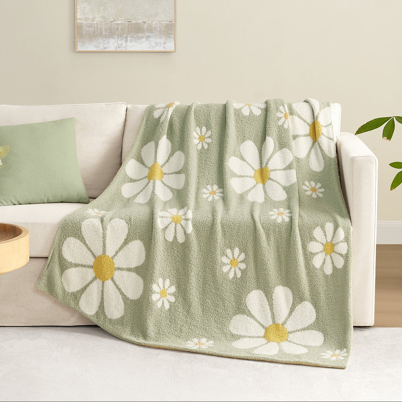 Spring Floral Feather Yarn Knit Throw Blanket drapped over a white couch in a bright room#Color_Sage Green