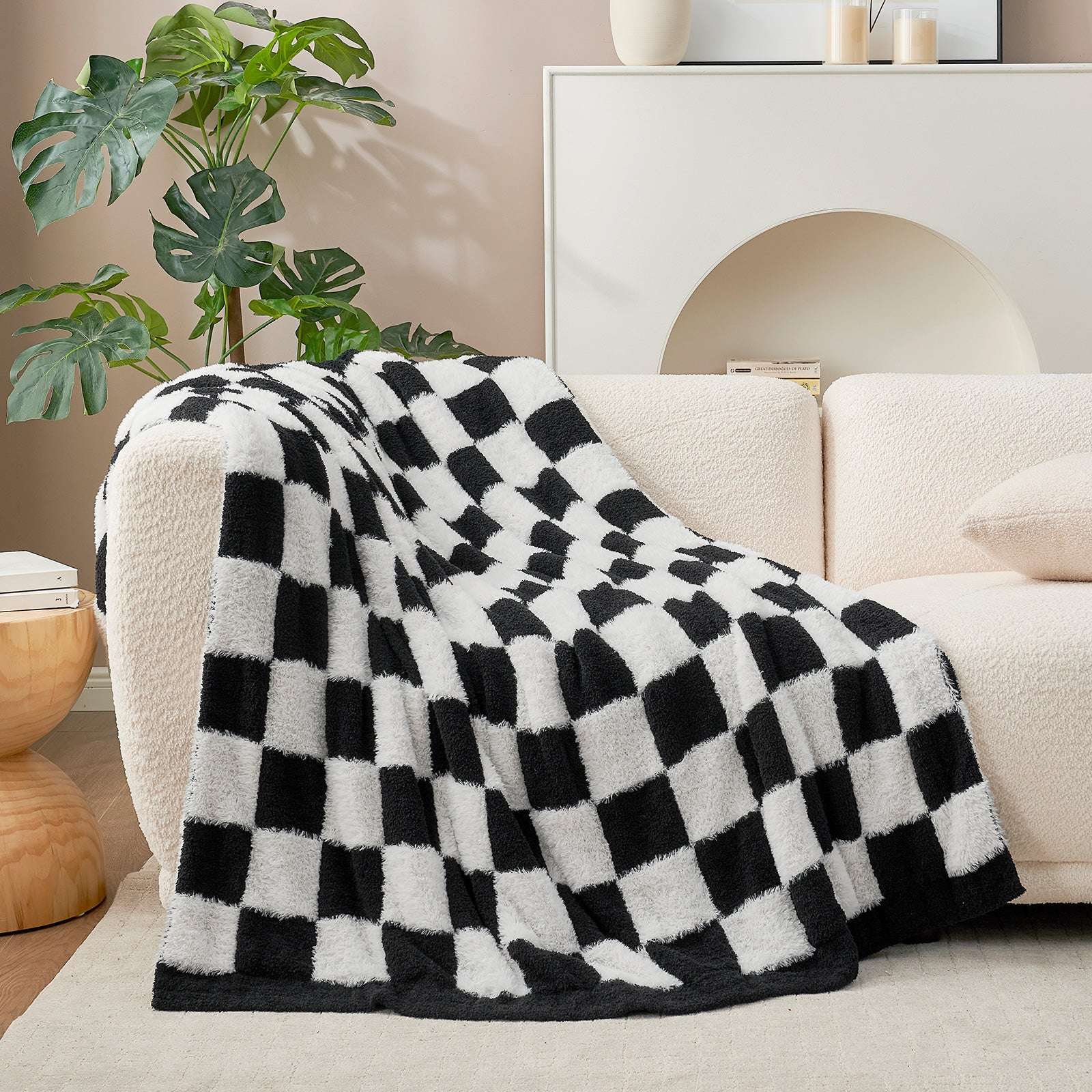 UltraCozy Checkered Feather Yarn Knit Throw Blanket on a beige couch #Color_Black White