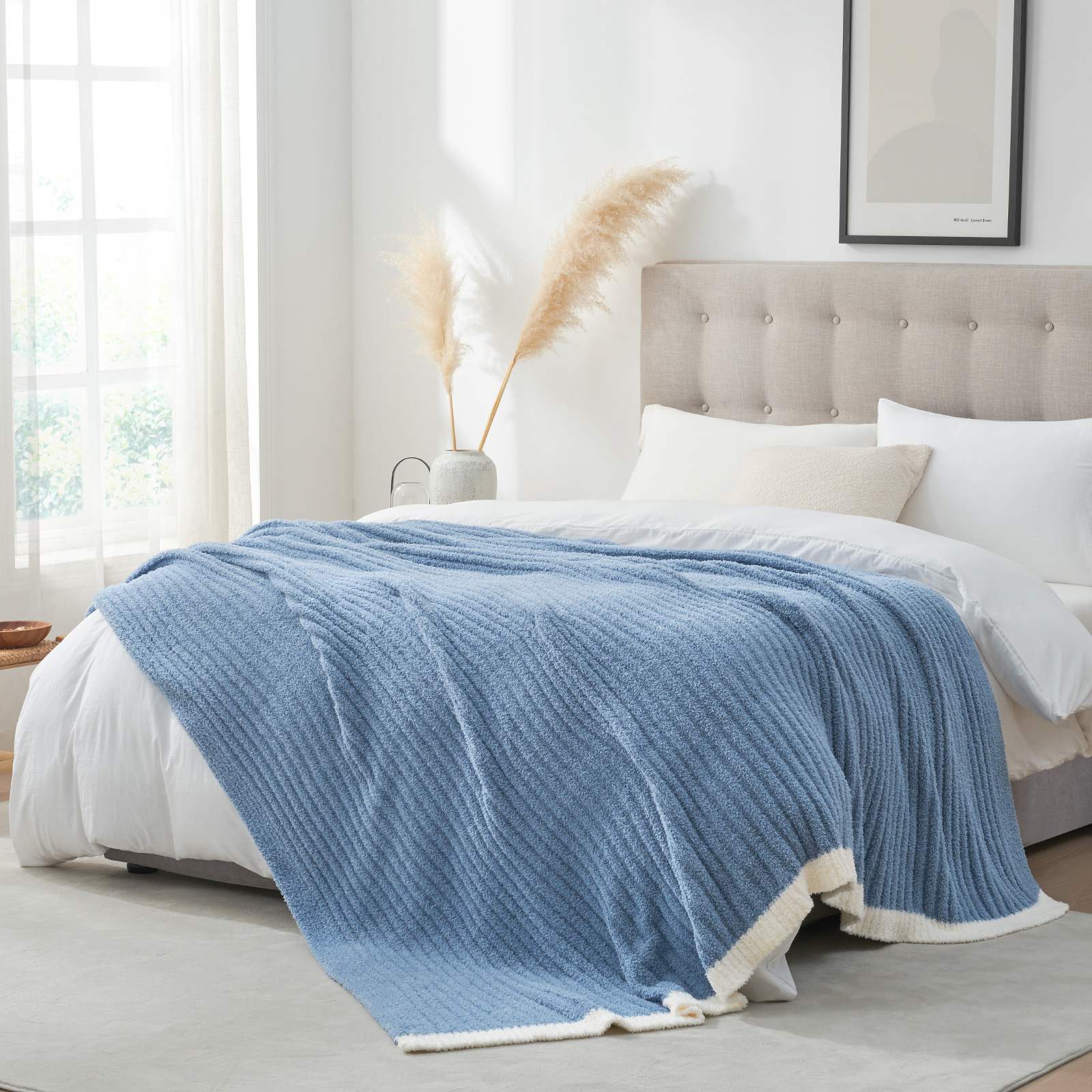 Snuggle Sac UltraSoft Ribbed Feather Yarn Knit Throw Blanket on the bed with window and furnitures#Color_Blue