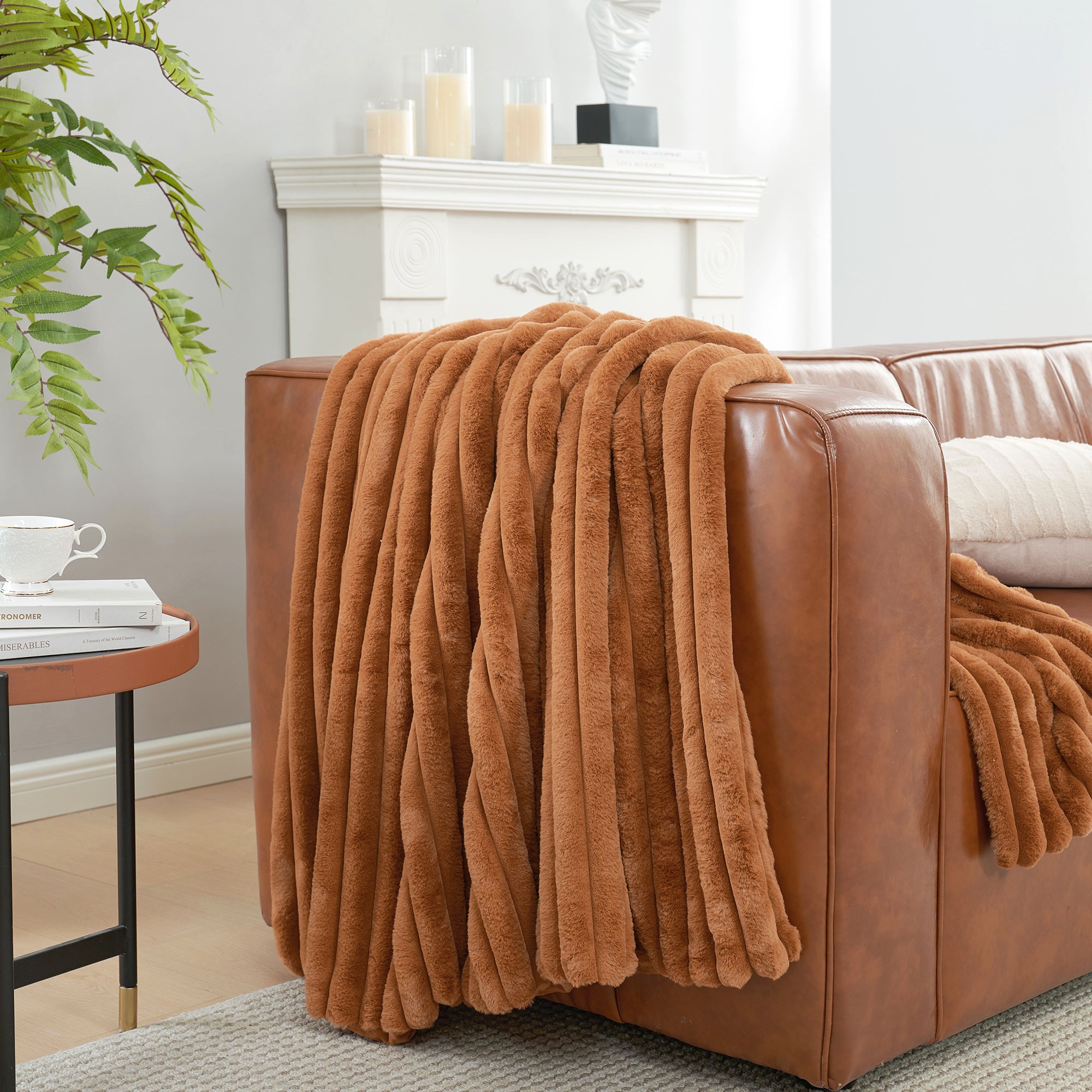 Striped faux fur throw blanket in Burnt Orange draped over a sofa, creating a clean and cozy living space #color_Burnt Orange