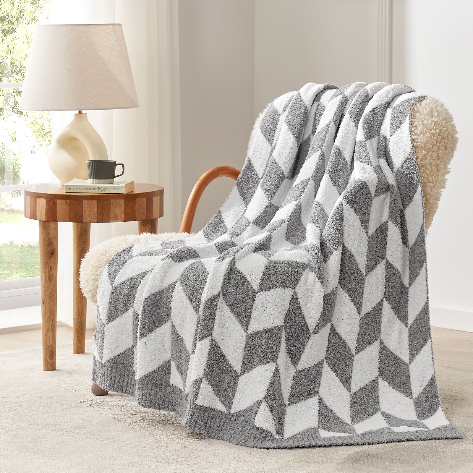 Snuggle Sacs Chevron Feather Yarn Knit Throw Blanket on the chair with lamp and window behind#color_Grey