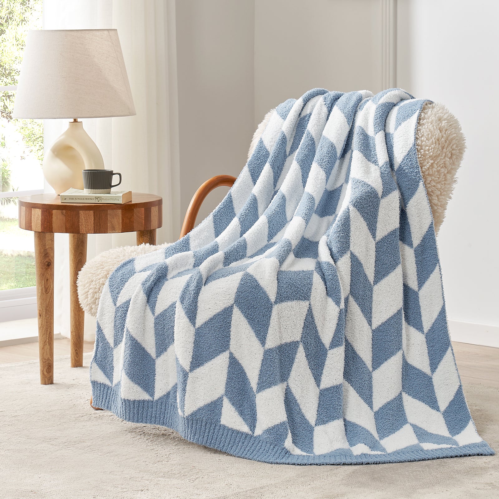 Snuggle Sacs Chevron Feather Yarn Knit Throw Blanket on the chair with lamp and window behind#color_Blue