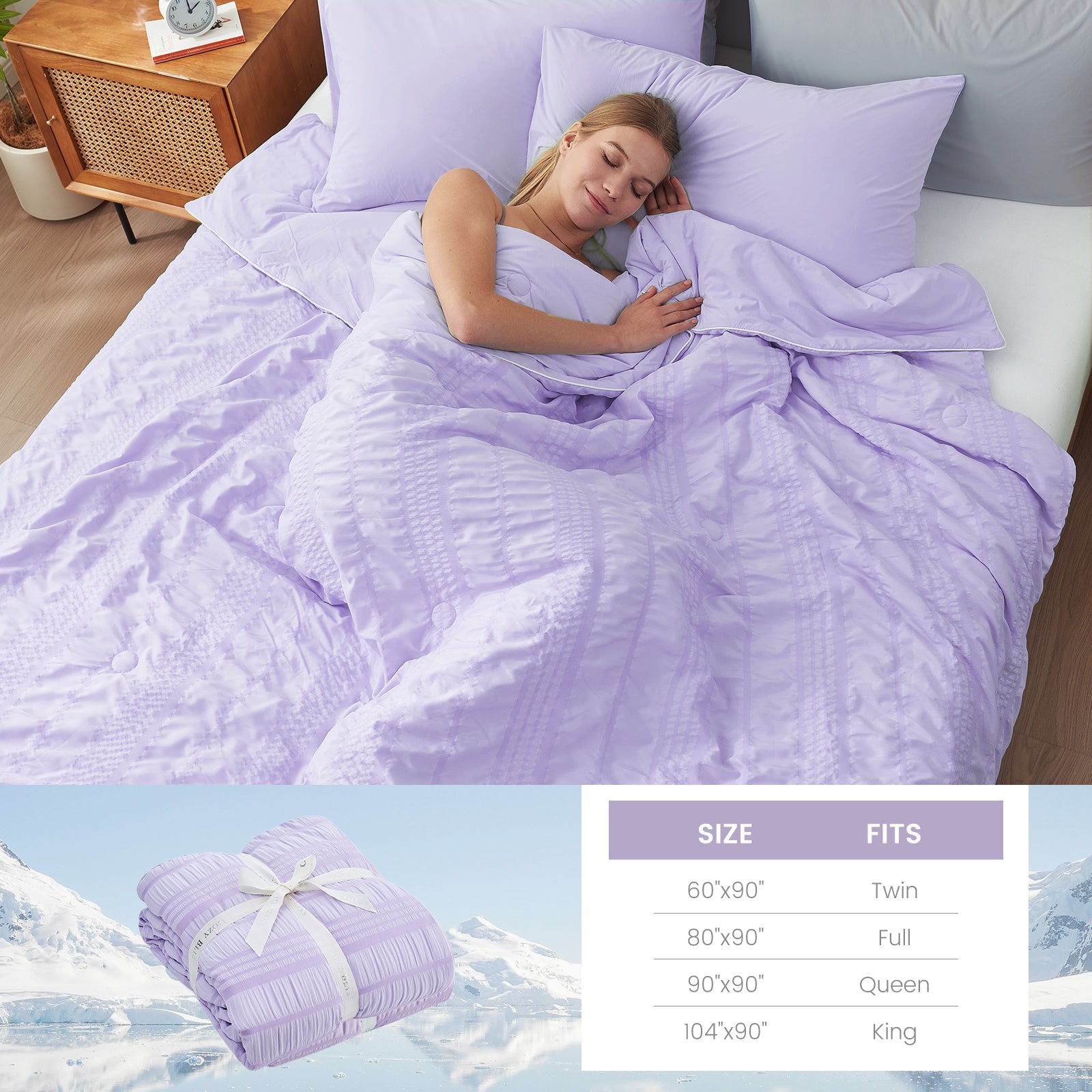 A woman laying down on the bed with Snuggle Sac Cooling comforter #color_Purple