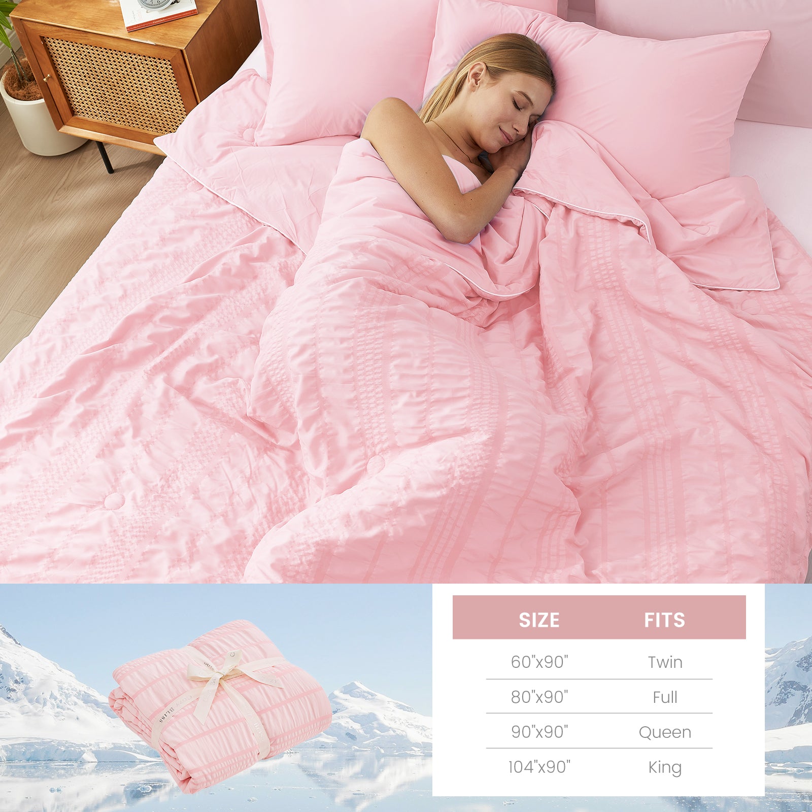 A woman laying down on the bed with Snuggle Sac Cooling comforter #color_Pink
