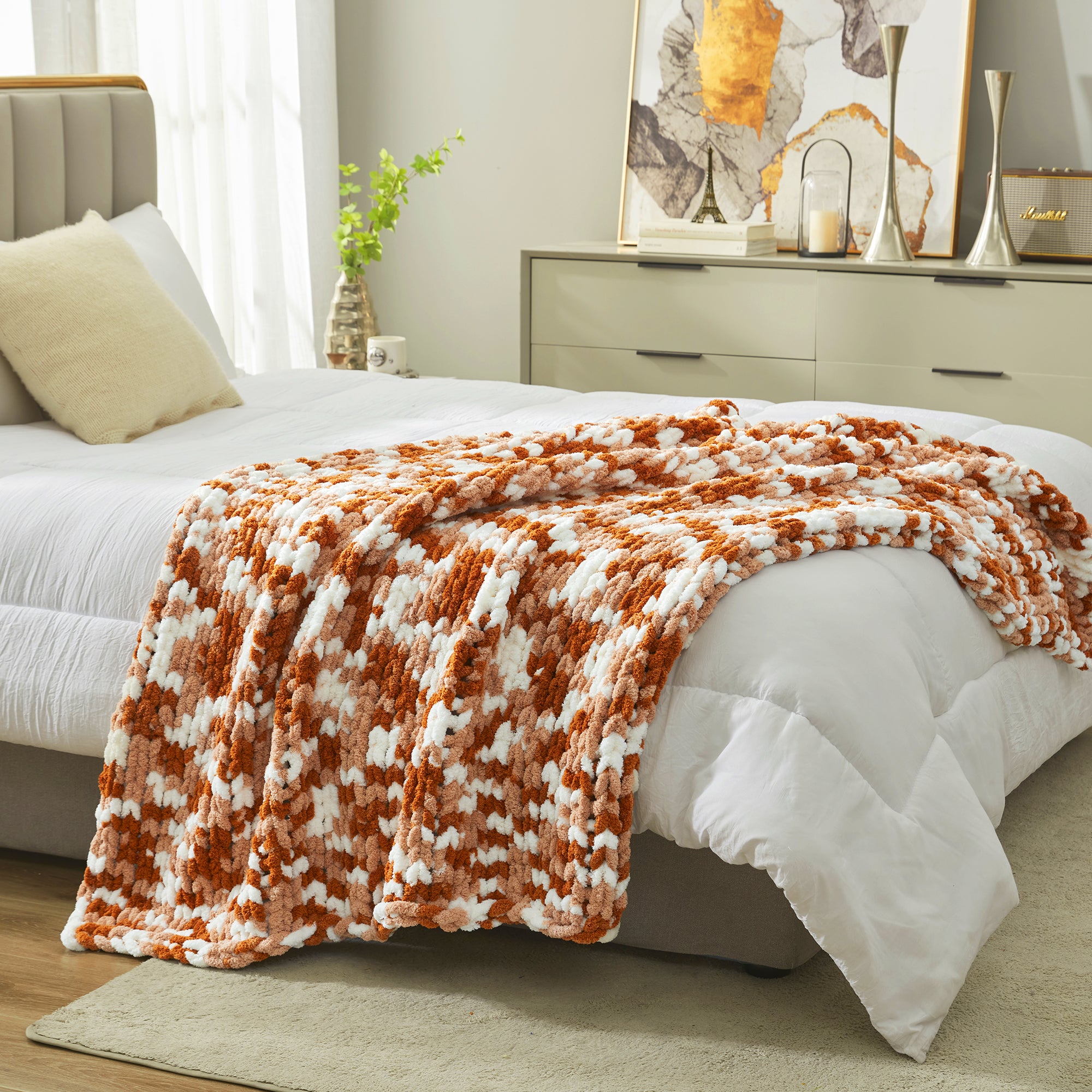 Chunky chenille knit throw blanket in Burnt Orange placed at the end of a bed adding texture and warmth #color_Burnt Orange