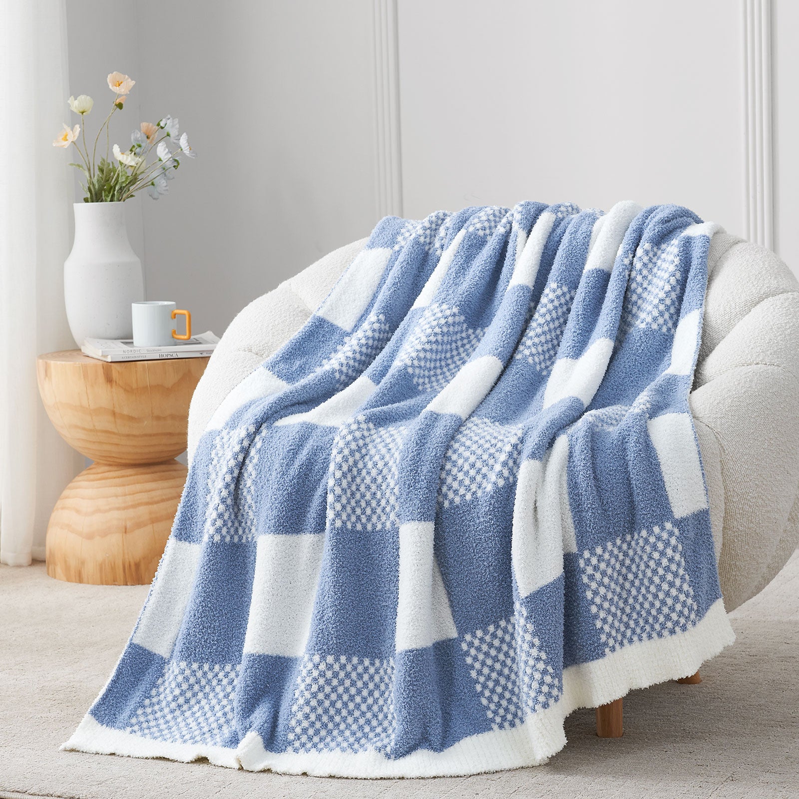 Blue and white checkered blanket draped over a chair in a cozy room. #color_Pale Blue