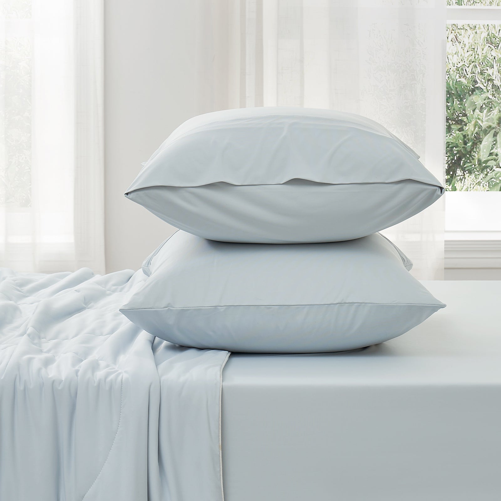 Side view of Snuggle Sac cooling fitted sheet and pillowcase set#color_Blue