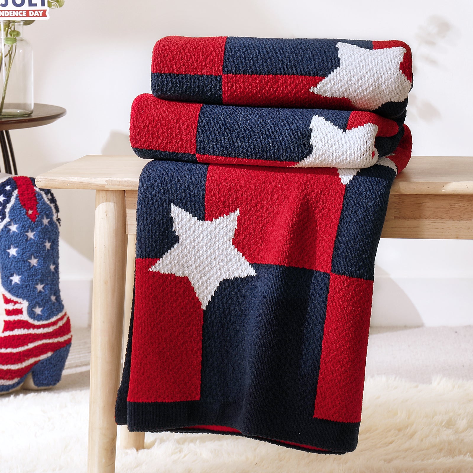 Snuggle Sac Independent Day chenille knit throw blanket in Red White neatly folded on a wooden table showcasing star pattern #color_Red White