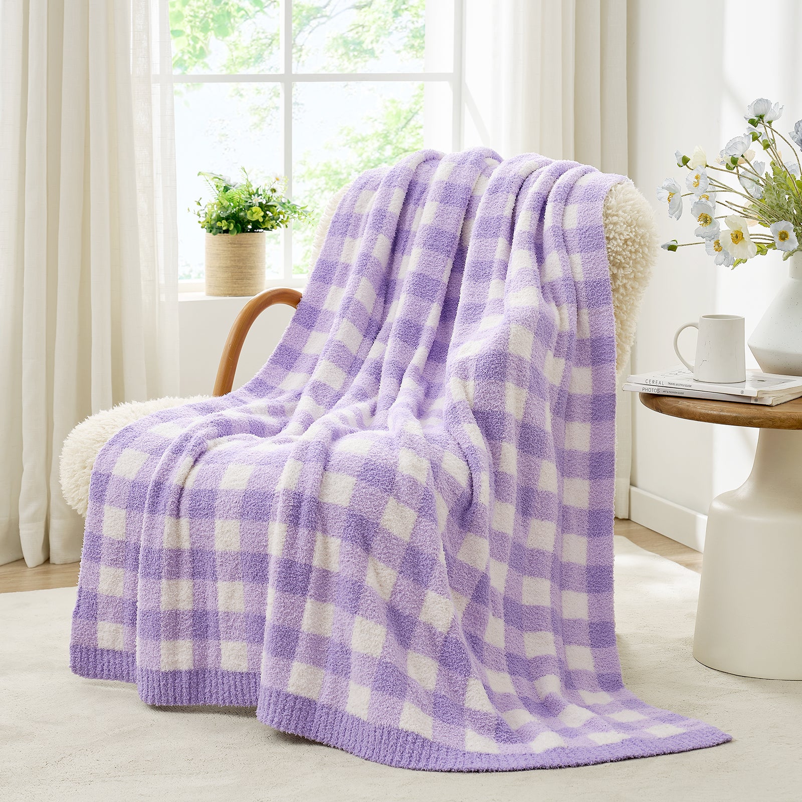 Purple and white checkered blanket draped over a chair in a bright room with a vase of flowers#color_Purple