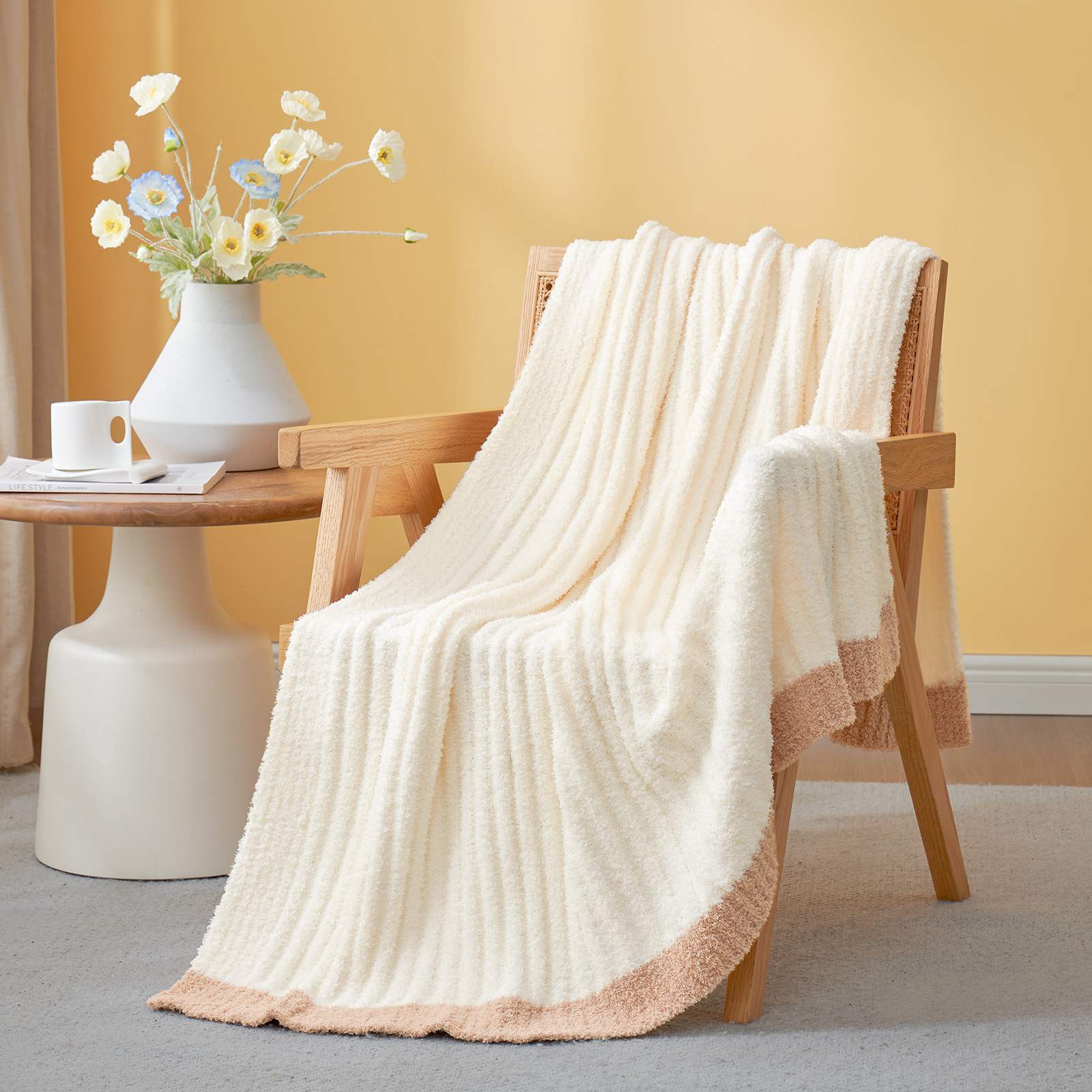 Snuggle Sac UltraSoft Ribbed Feather Yarn Knit Throw Blanket draped on the chair with a vase of flower#Color_Cream