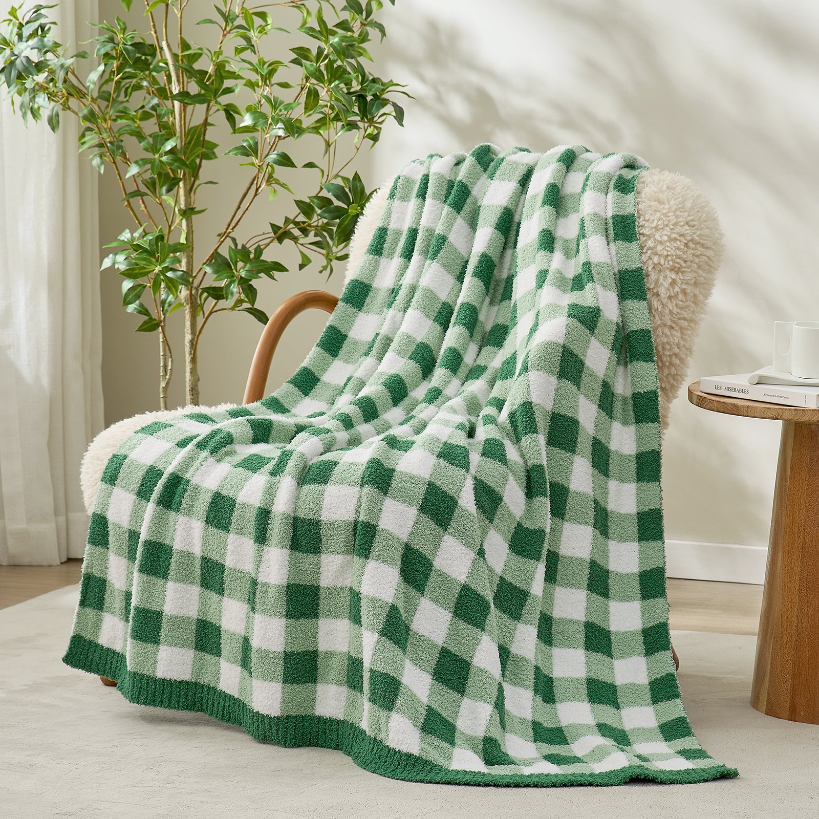 Green and white checkered blanket draped over a chair in a bright room with a vase of plants #color_Green