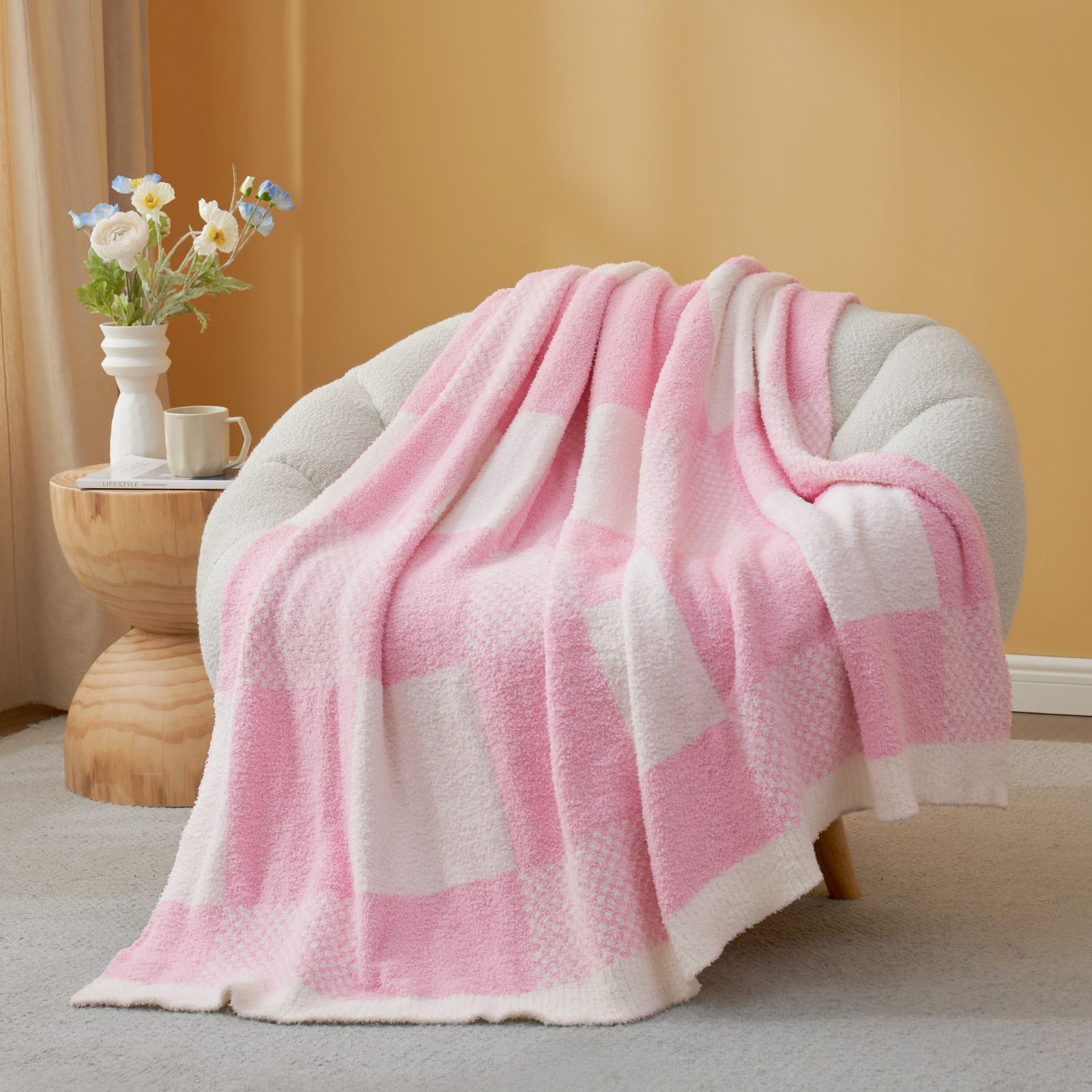 Snuggle Sac Checkered Feather Yarn Knit Throw Blanket on the chair with furnitures behind#color_Pink